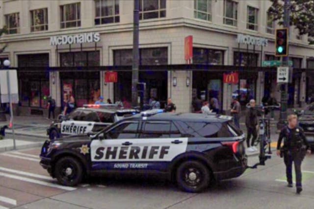 <p>A McDonald’s in downtown Seattle has banned indoor dining by barring the doors and creating an improvised takeout window</p>