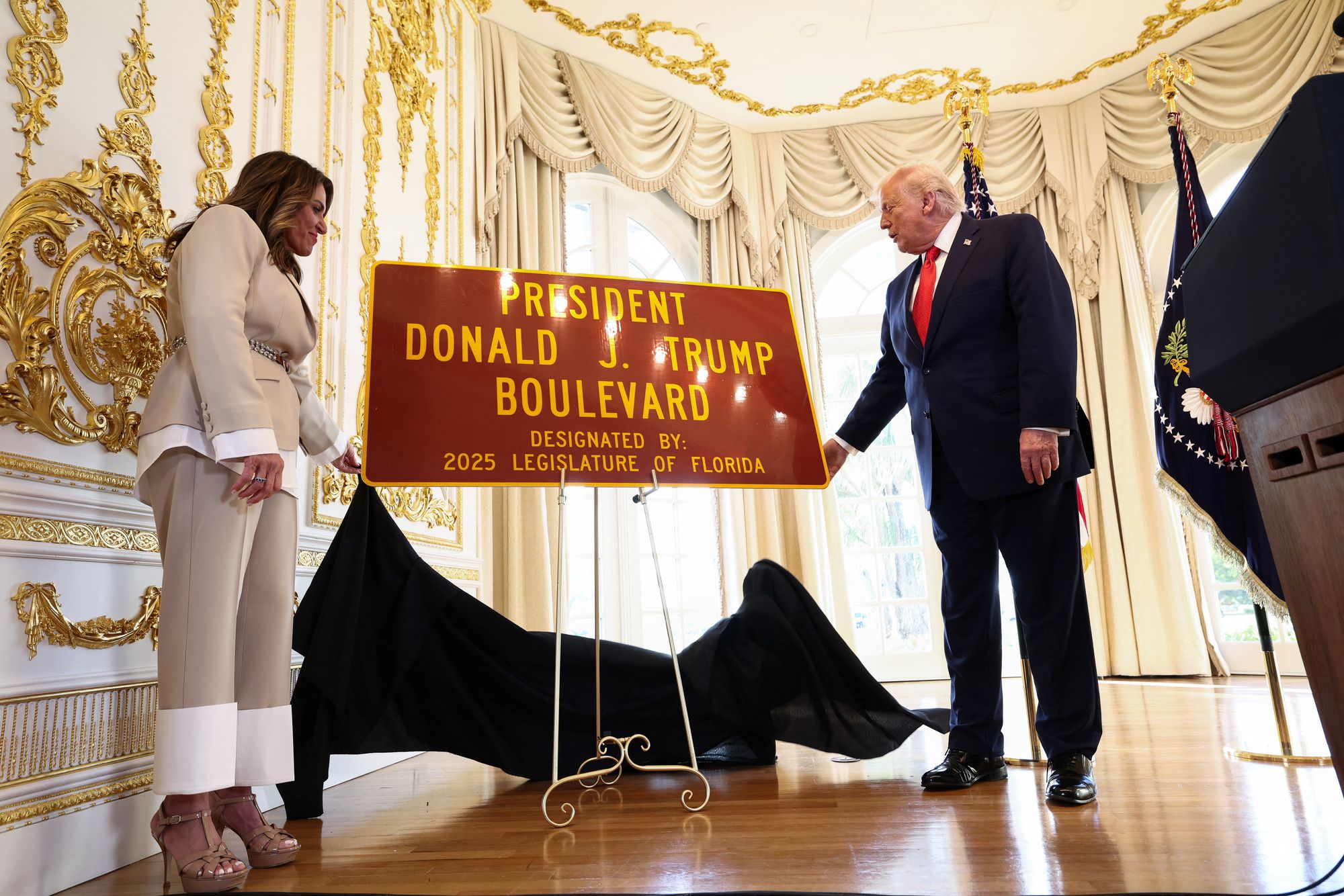 <p>President Donald Trump unveils a 'President Donald J. Trump Boulevard' sign at a ceremony in Palm Beach, Florida</p>
