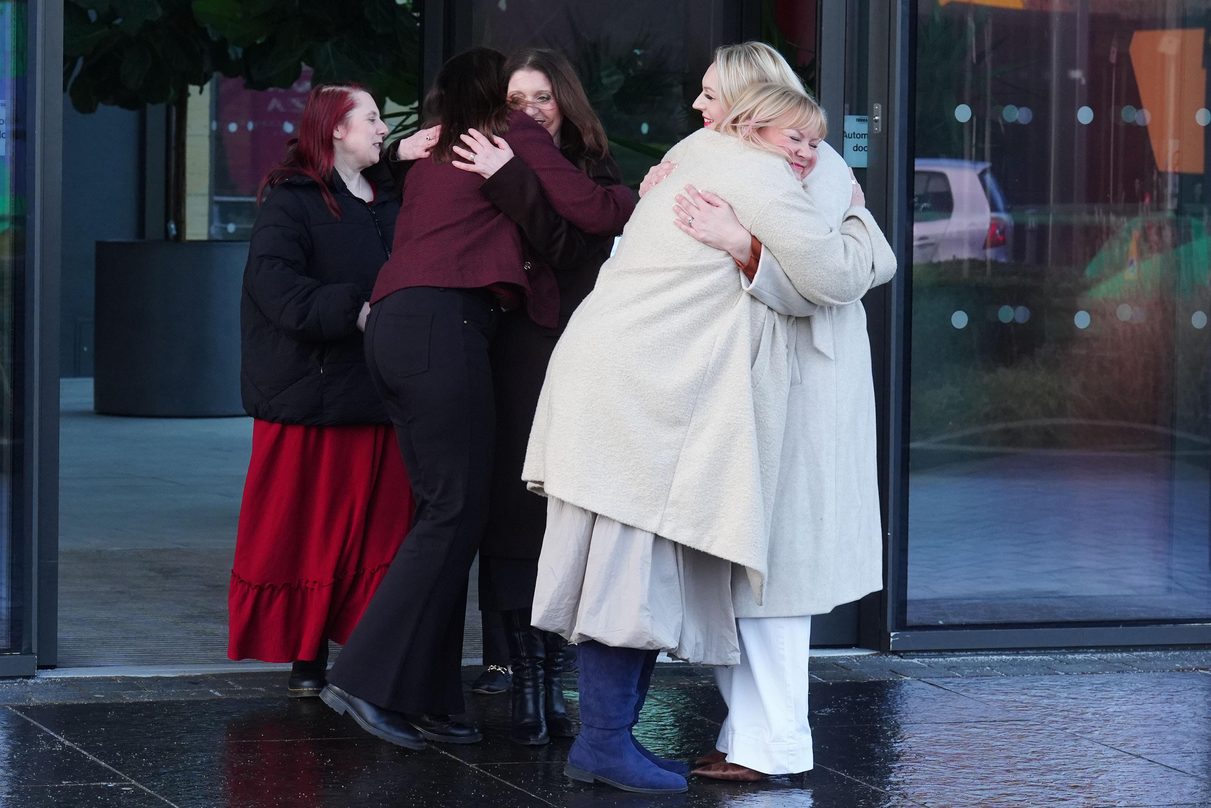 A group of nurses hug as they leave a press conference at the Crowne Plaza Hotel, Newcastle, after an employment tribunal ruled they suffered harassment which violated their dignity (Owen Humphreys/PA)