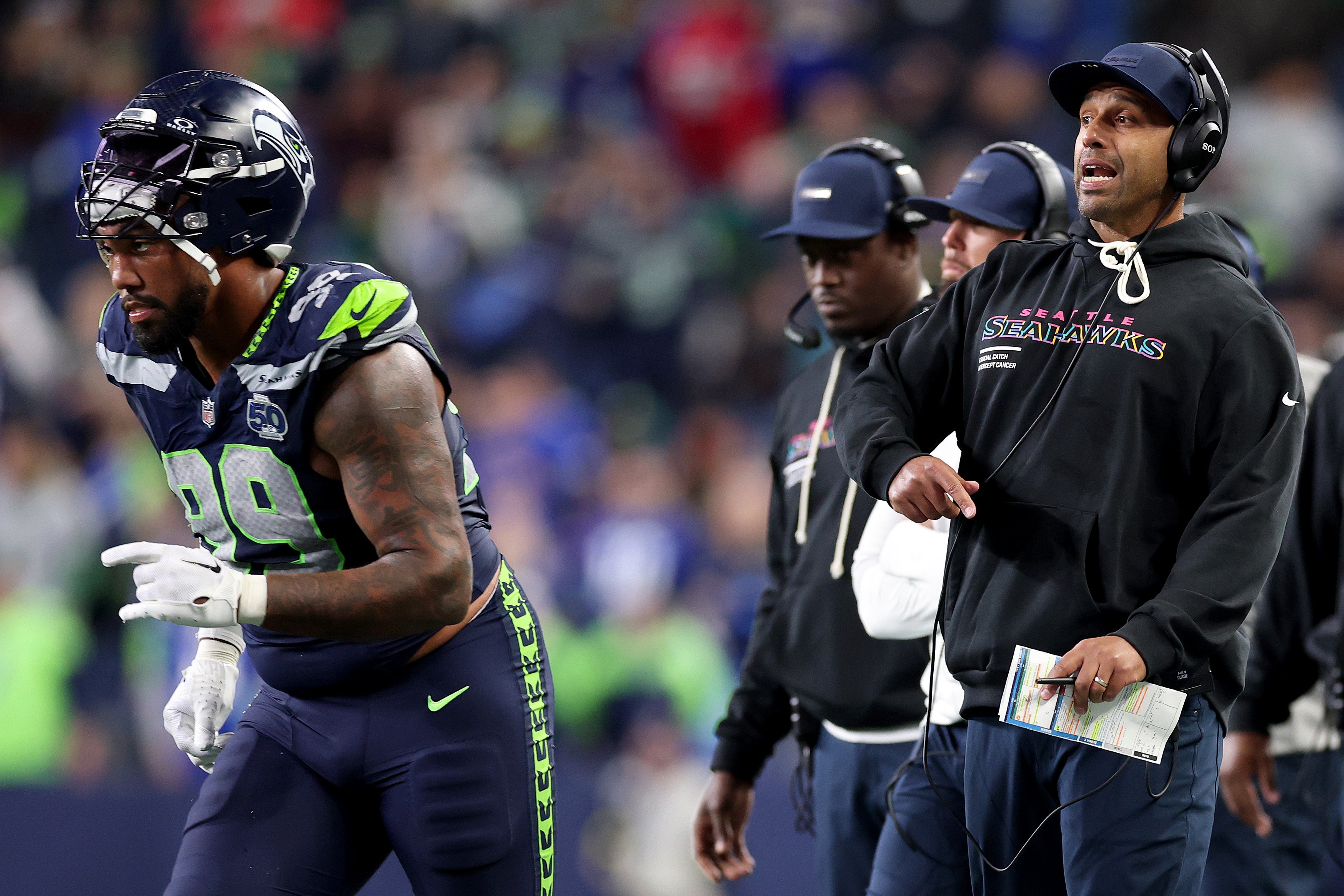 Defensive coordinator Aden Durde of the Seattle Seahawks reacts with Leonard Williams