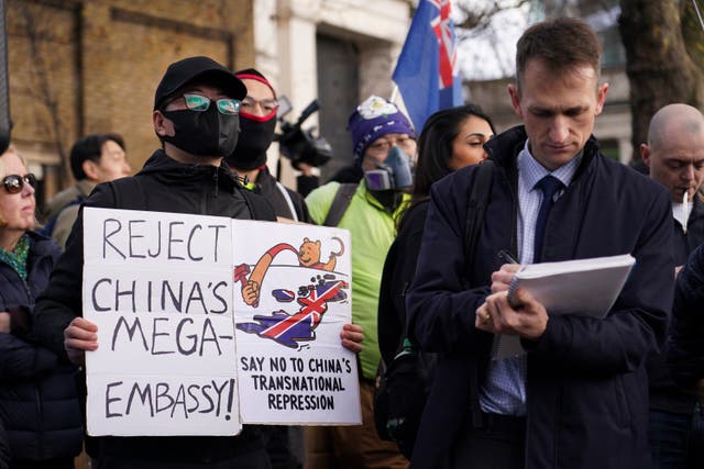 <p>Demonstrators hold placards and flags as they attend a protest against the opening of the new Chinese embassy, in London, Saturday, Jan. 17, 2026. (AP Photo/Alberto Pezzali)</p>