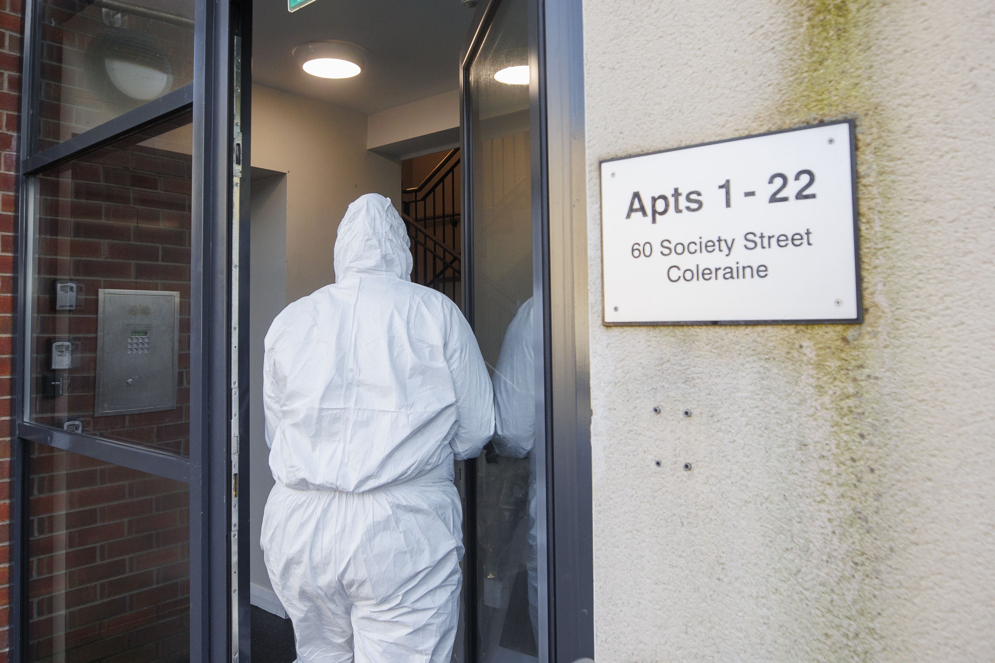 PSNI forensic officers enter an apartment building on Society Street in Coleraine connected to the death of Wayne Reid (Liam McBurney/PA)