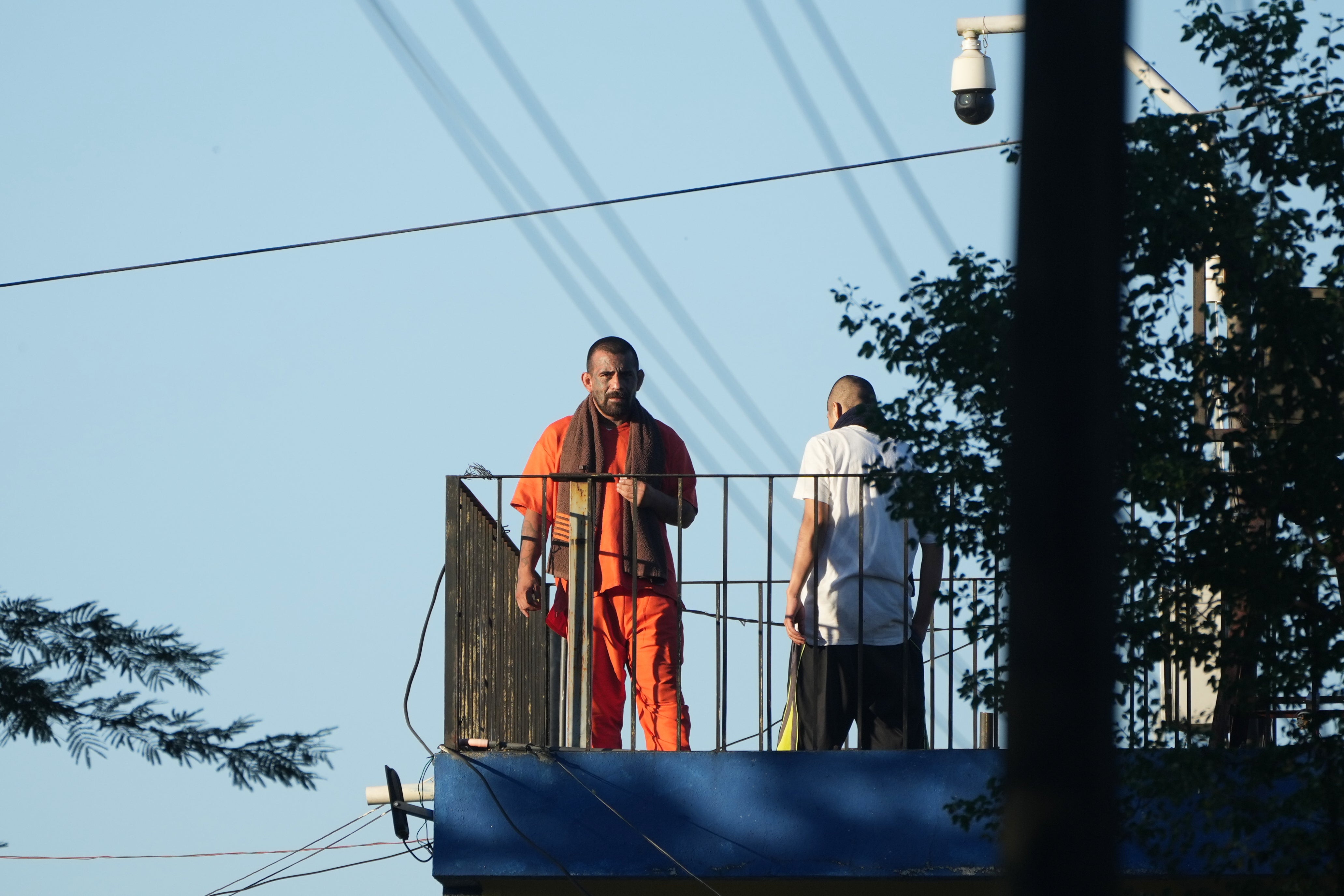Inmates stand atop a guard tower at the Renovation maximum-security prison before security forces entered the facility to free guards taken hostage