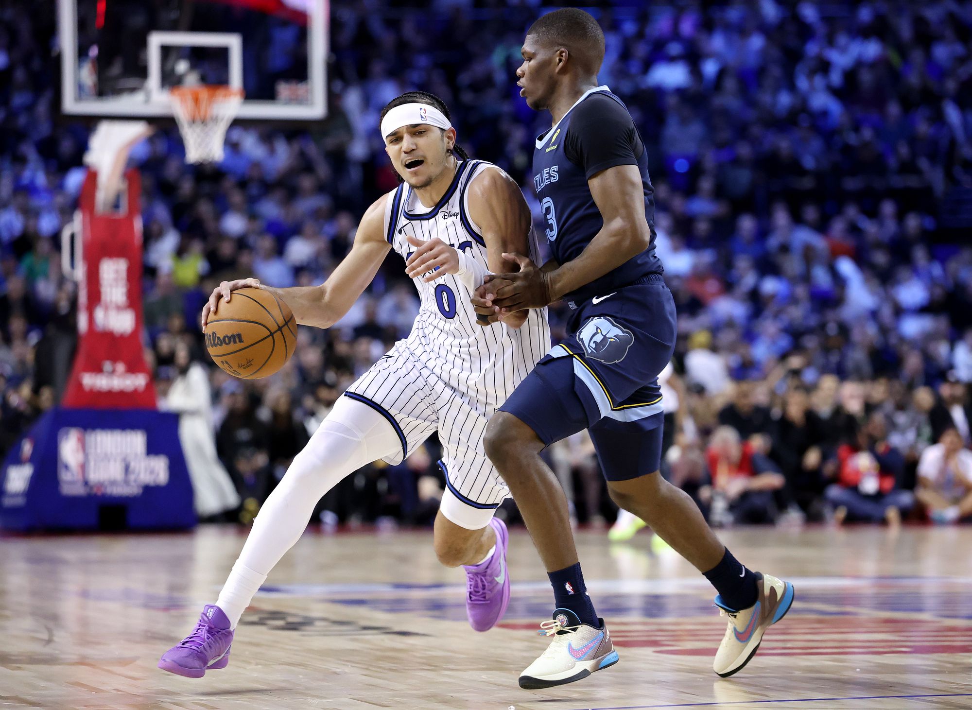 Memphis Grizzlies’ Cedric Coward (right) tries to contain the Magic’s Anthony Black