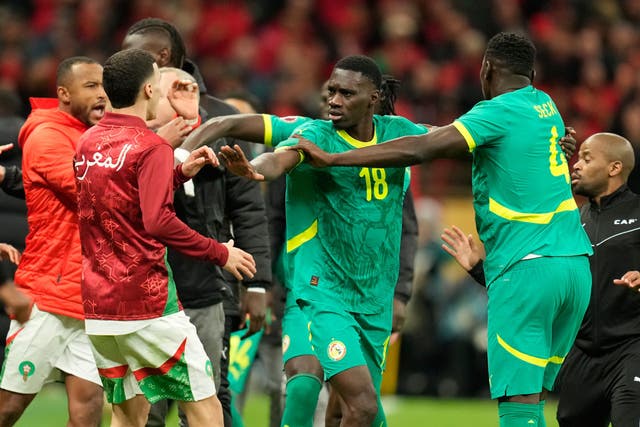 <p>Senegal's and Morocco's players scuffle after the late penalty call during the Africa Cup of Nations final</p>