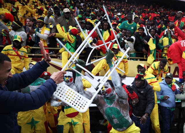 <p>Senegal fans try to invade the pitch amid the chaos of the Afcon final</p>