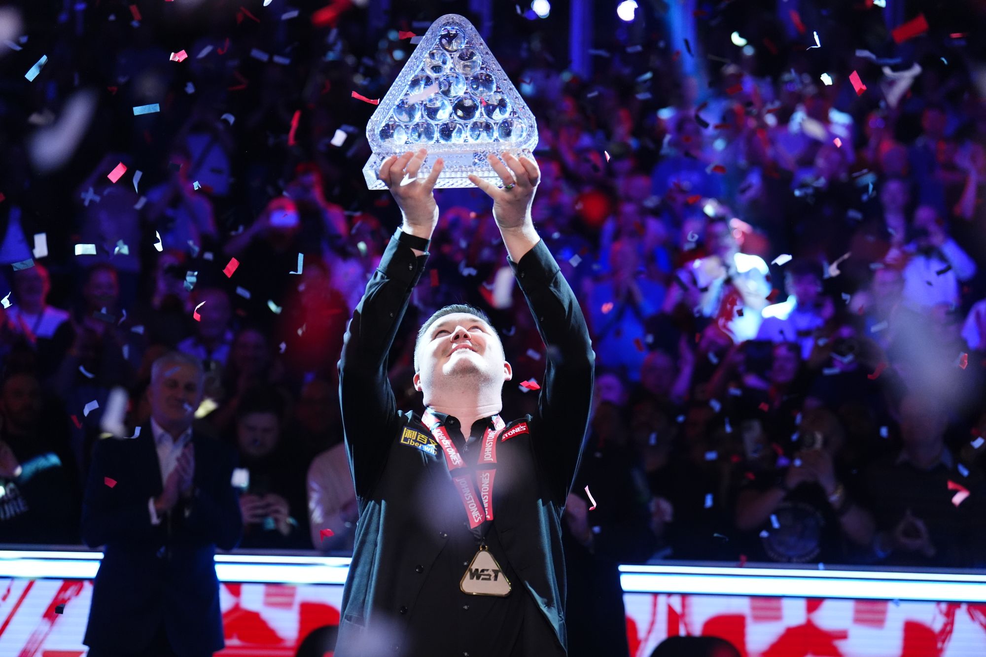 Kyren Wilson holds his Masters title aloft