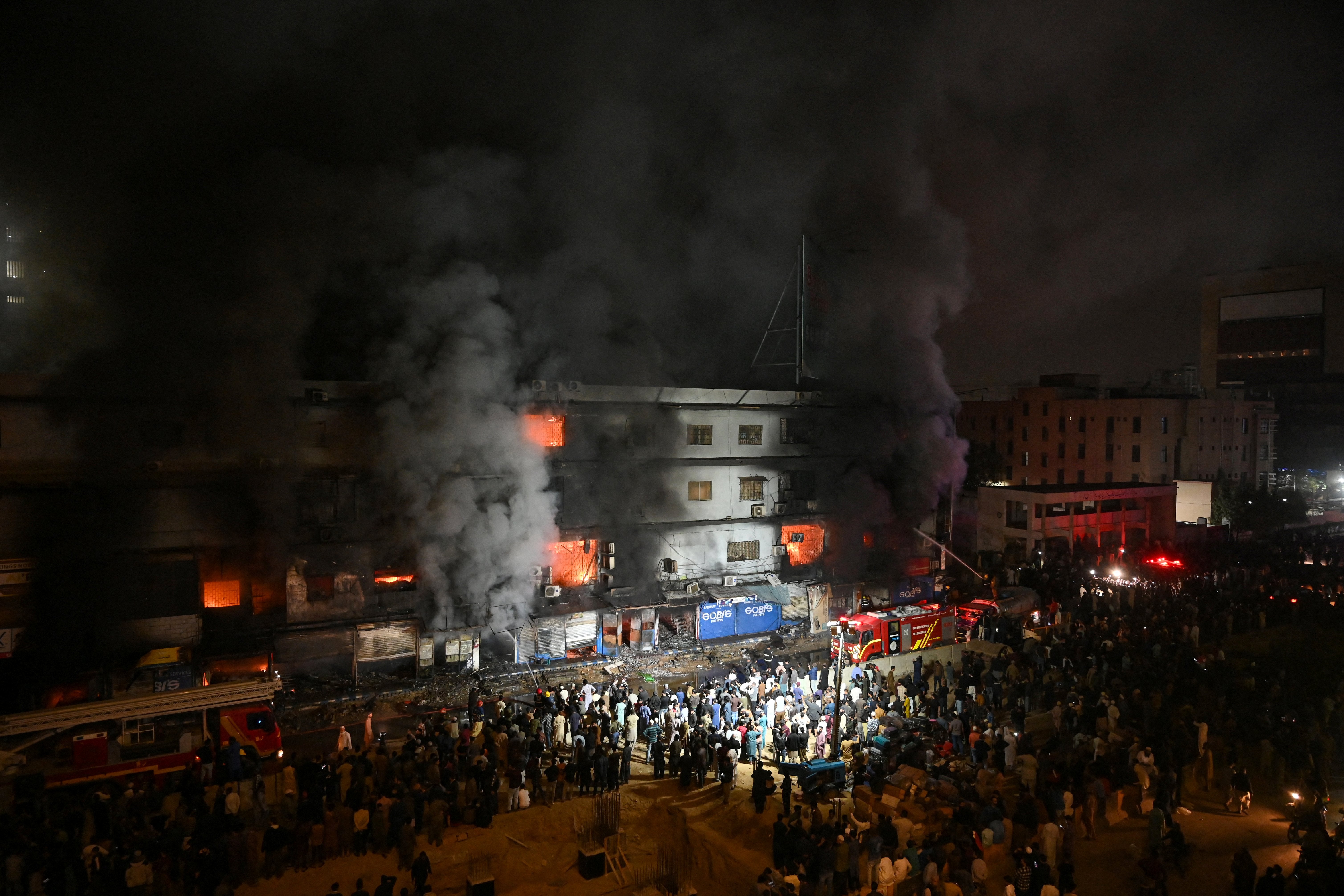 Firefighters douse a fire that broke out at a shopping mall in Karachi on 18 January