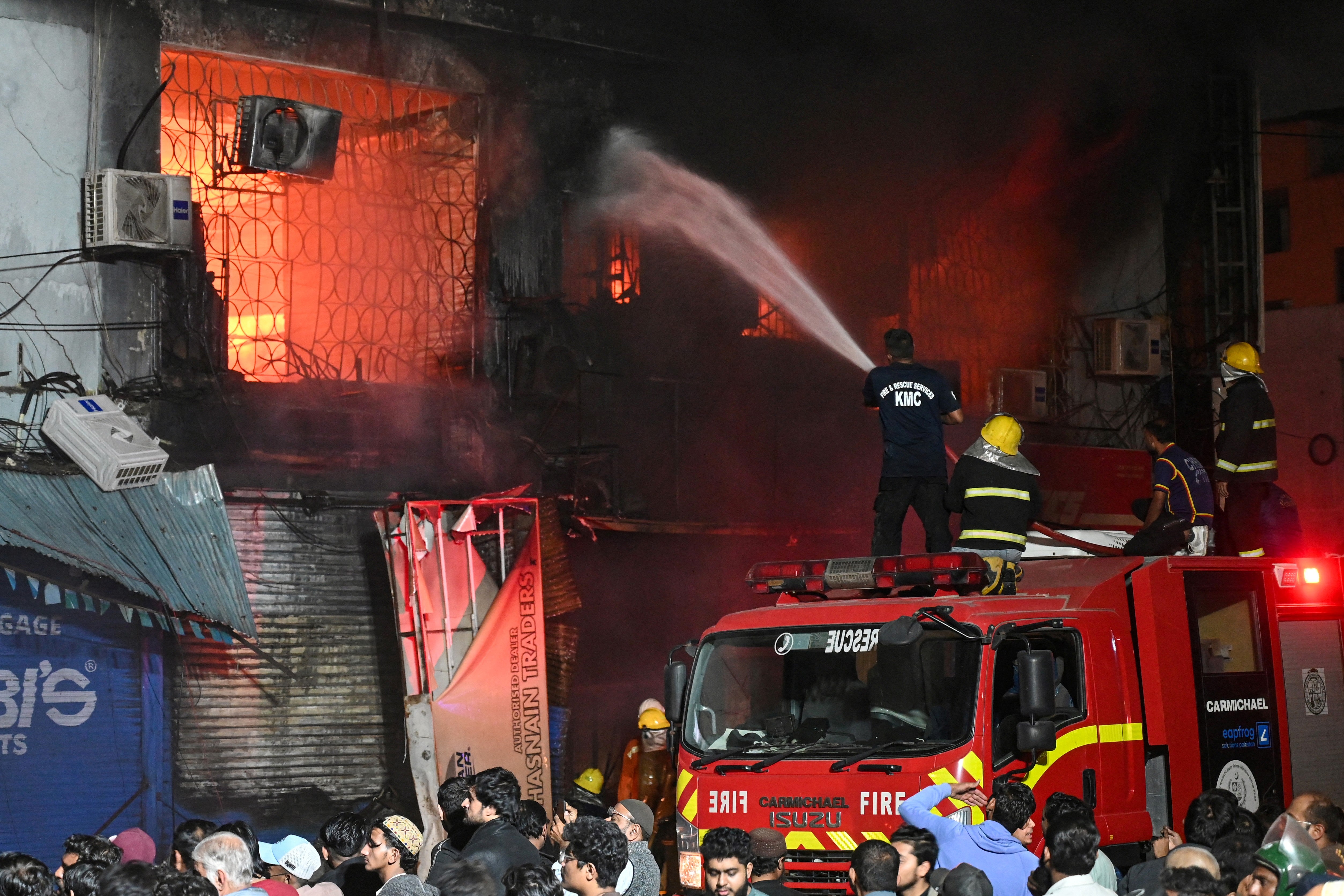 Firefighters douse a fire that broke out at a shopping mall in Karachi
