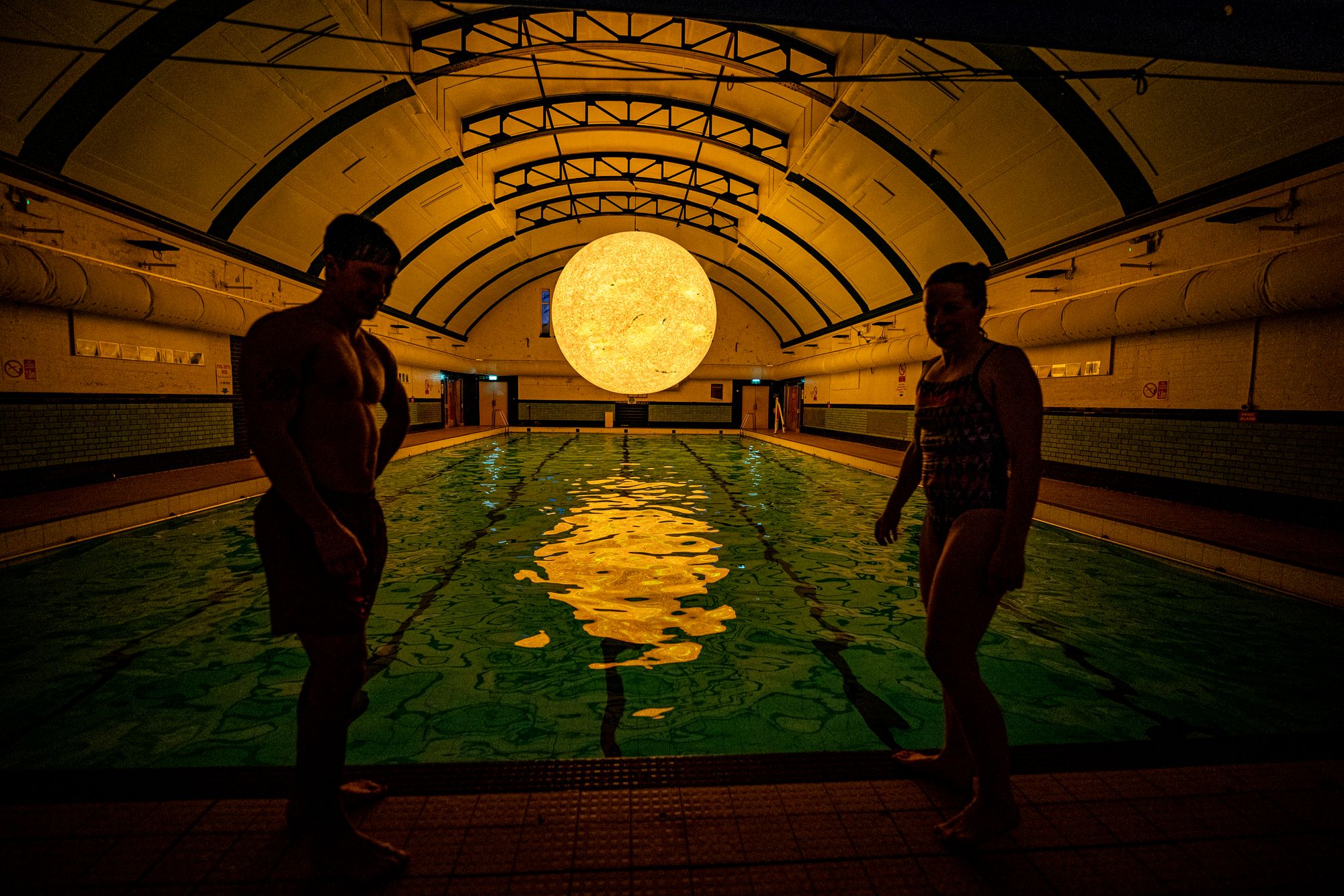 People get ready for a swim beneath ‘Helios’