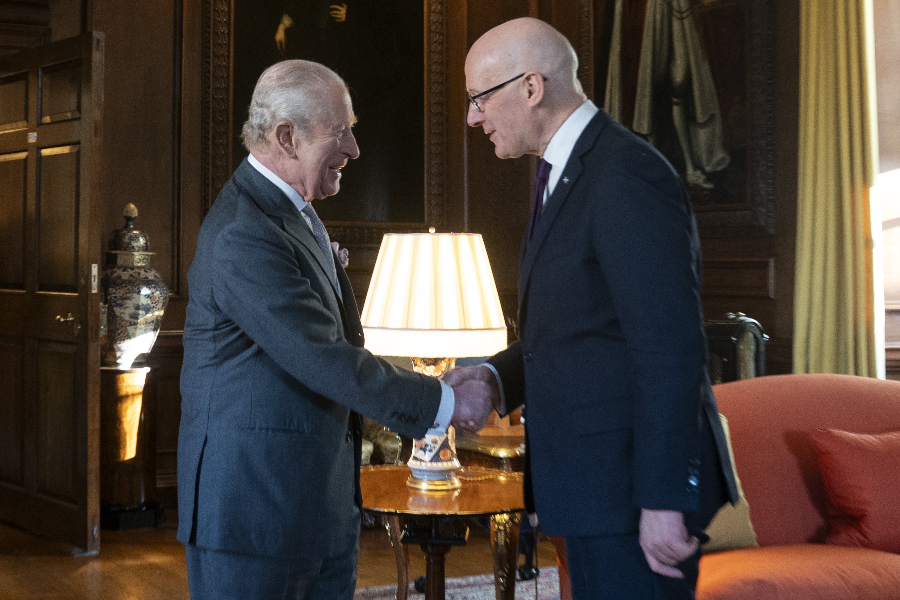 King Charles meets the First Minister of Scotland John Swinney during a reception at the Palace of Holyroodhouse