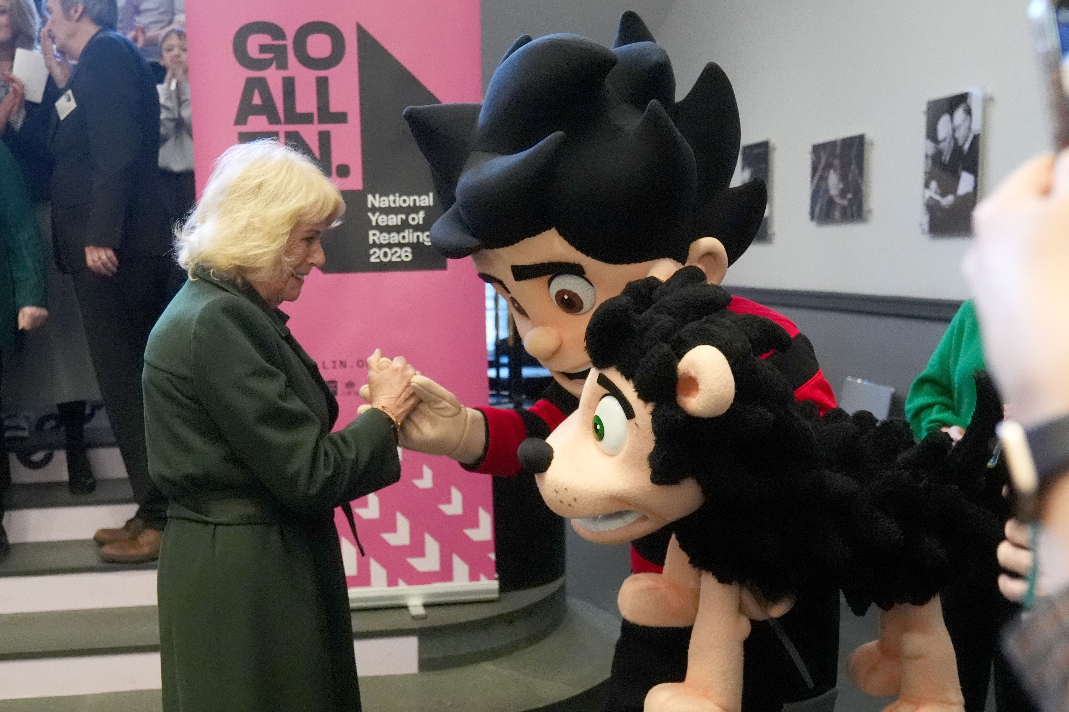 Camilla meets Dennis the Menace and Gnasher during a visit to National Library of Scotland (Andrew Milligan/PA)