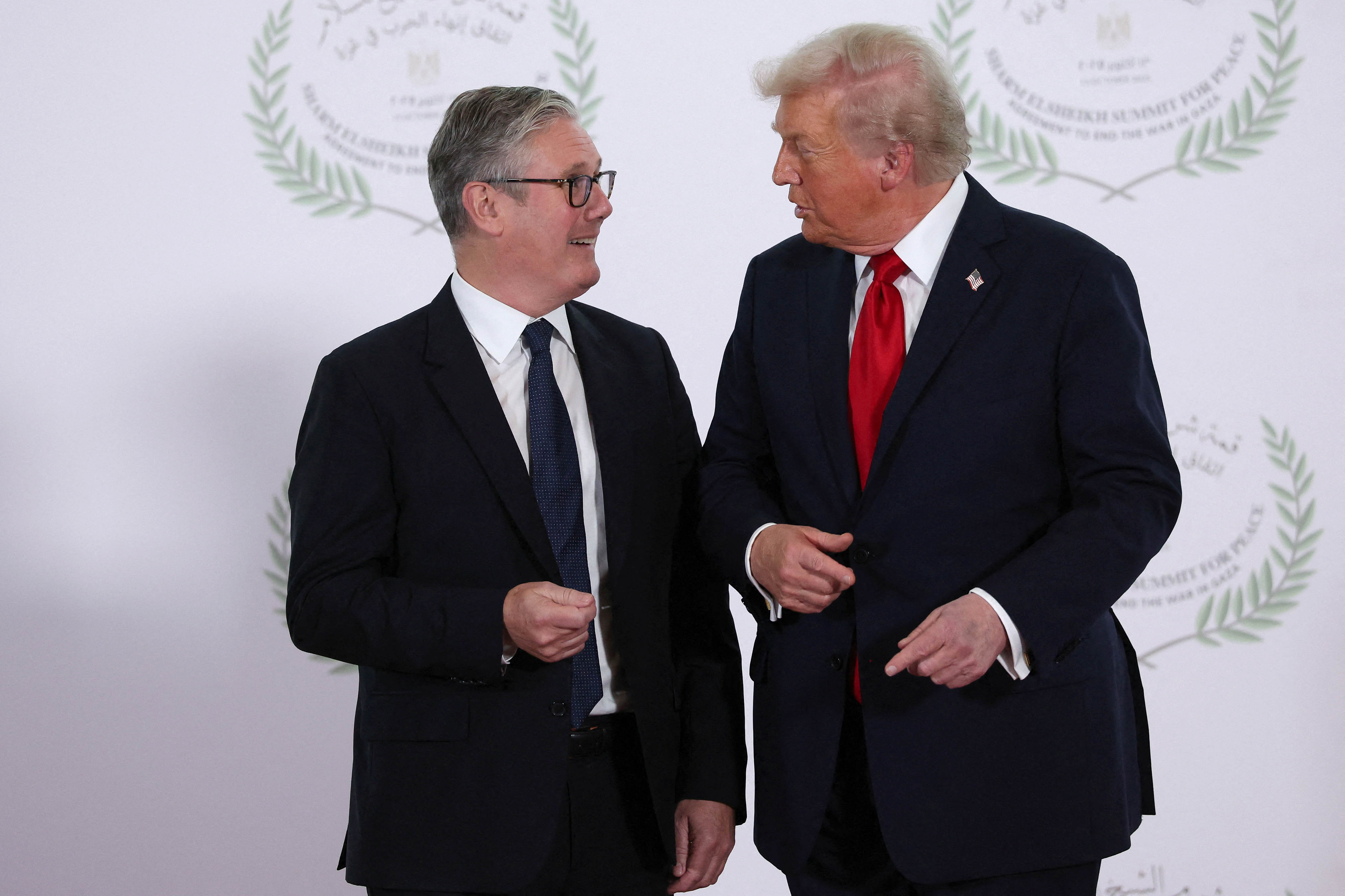 US President Donald Trump and Prime Minister Sir Keir Starmer speak as they pose for a photo at the Sharm El Sheikh Peace Summit in Egypt. Picture date: Monday October 13, 2025.