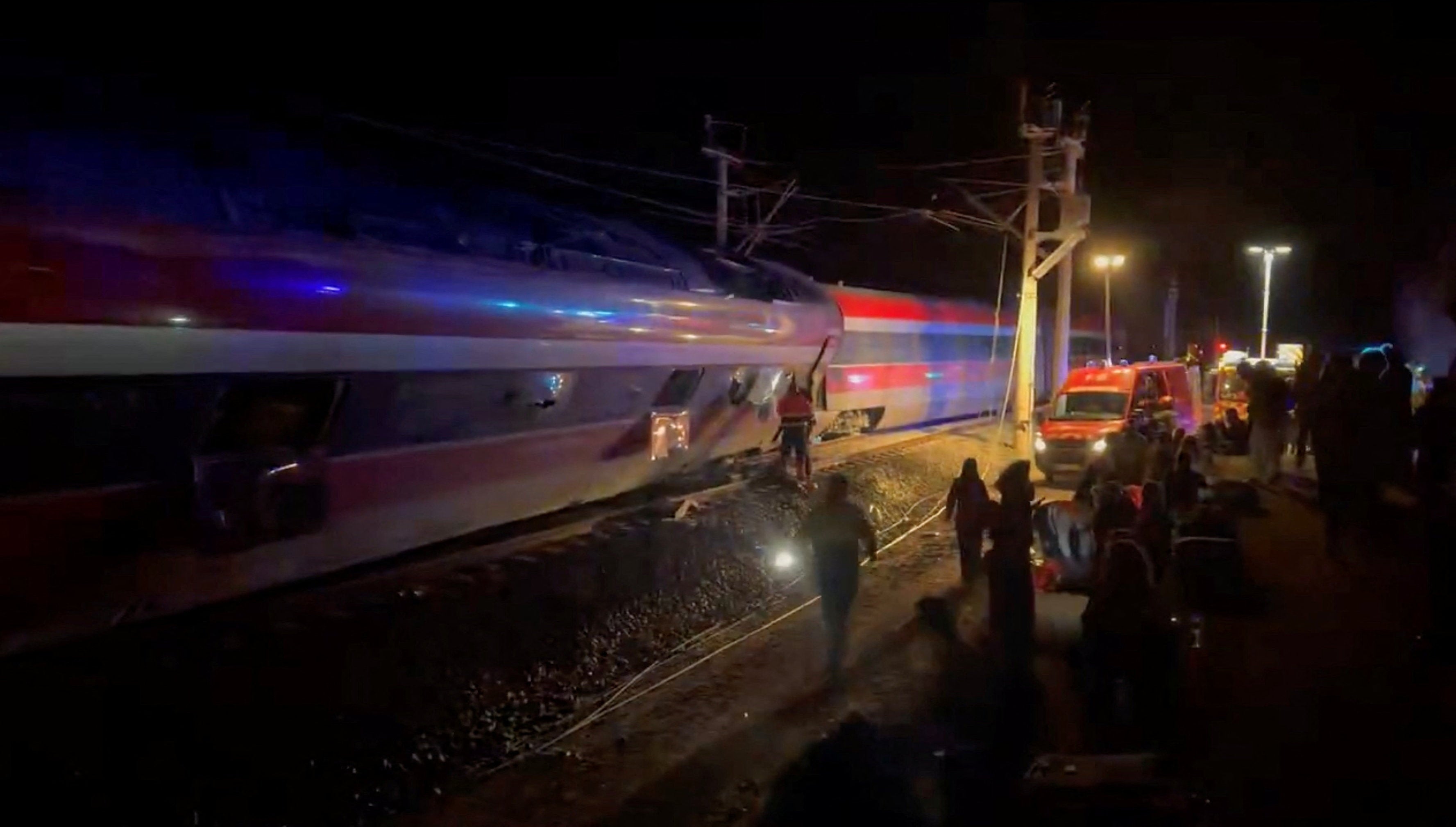 Emergency responders work at the site after a high-speed train derailed and smashed into another oncoming train, near Adamuz, in Cordoba province, Spain, January 18, 2026