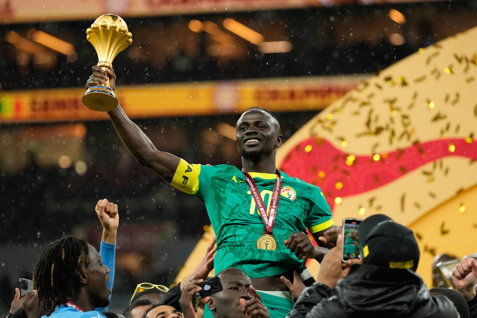 <p>Sadio Mane celebrates with the Africa Cup of Nations trophy</p>