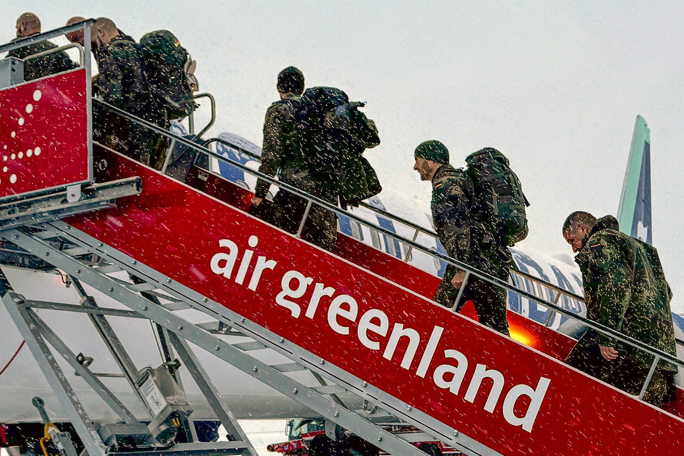 Military personnel from the German armed forces board a flight leaving Nuuk airport for Reykjavik on Sunday