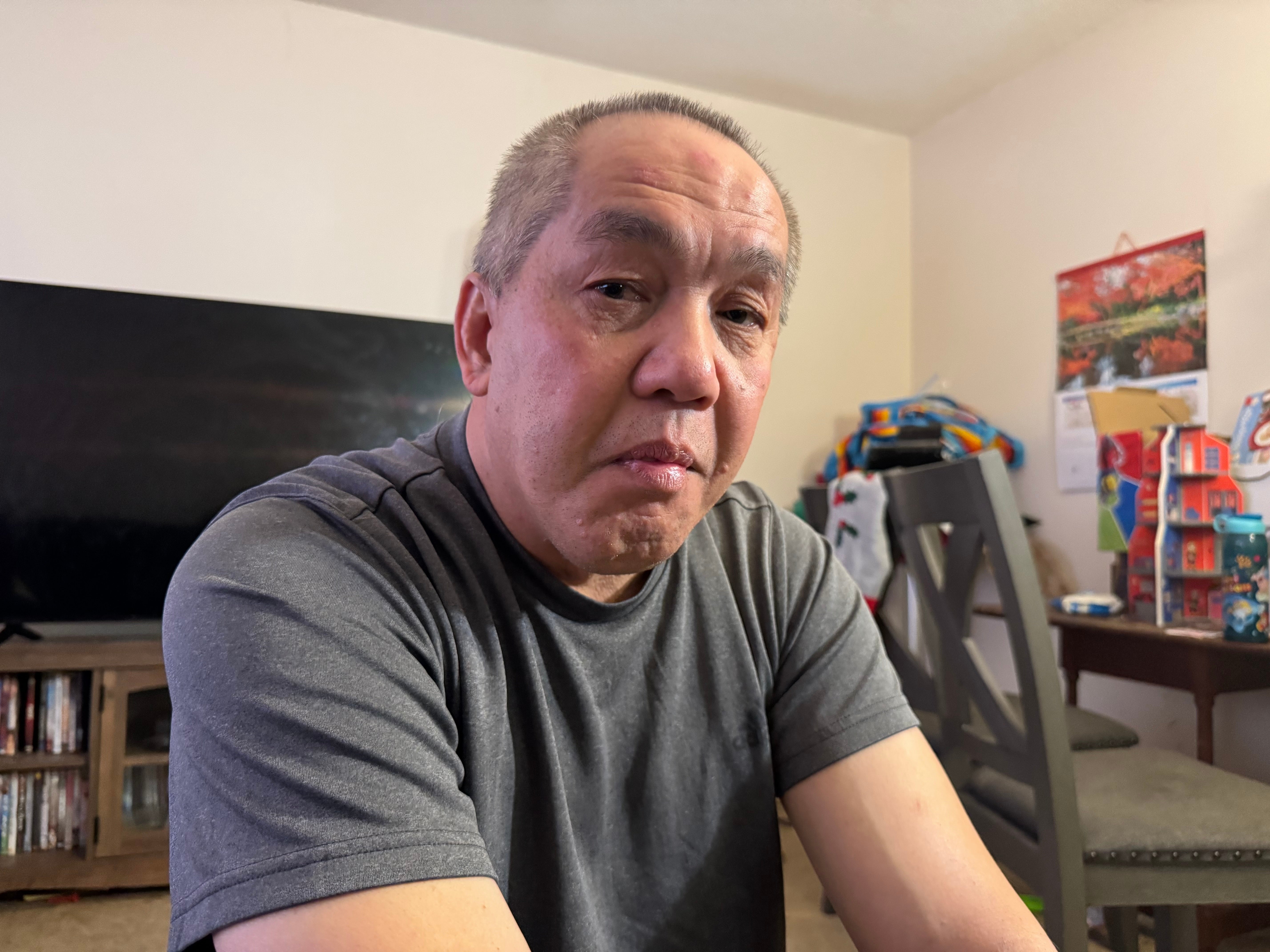 Chongly "Scott" Thao, a U.S. citizen, sits for a photo at his home Monday, Jan. 19, 2026, in St. Paul, Minn., the day after federal agents broke open his door and detained him without a warrant