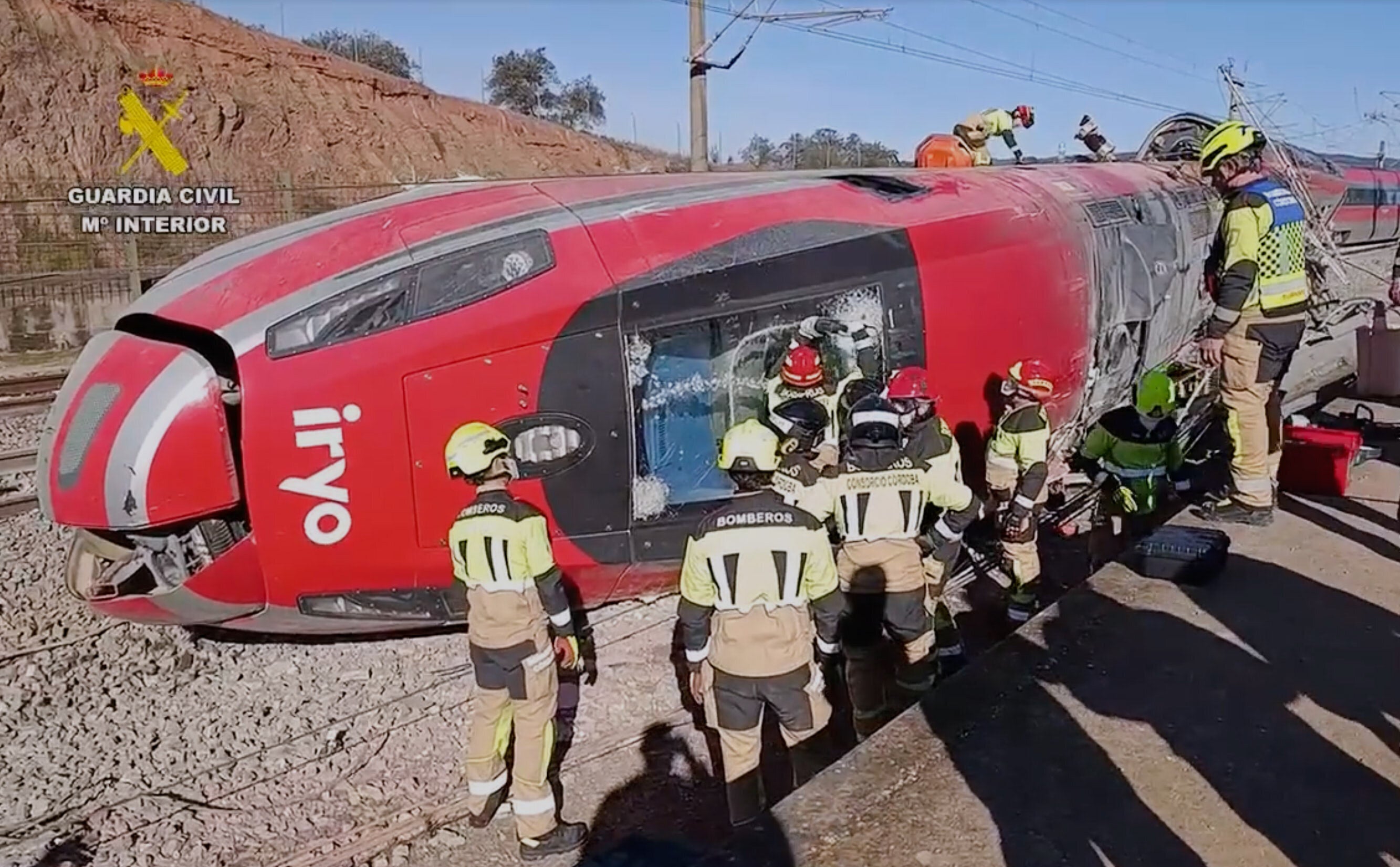 In this grab taken from video provided by Guardia Civil, rescue workers at the scene following a high-speed train collision, in Adamuz, Spain, Monday, Jan. 19, 2026. (Guardia Civil via AP)