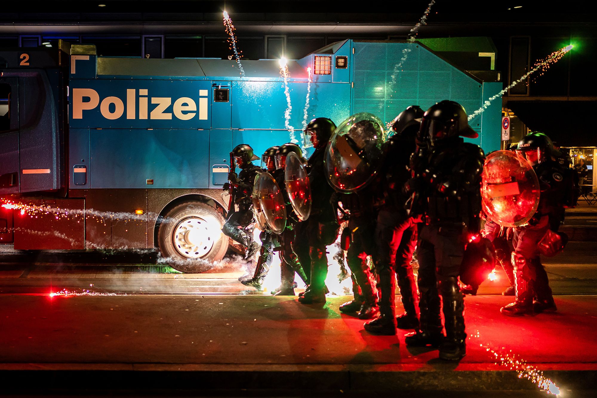 Riot police clash with protesters during demonstrations against the WEF and Trump