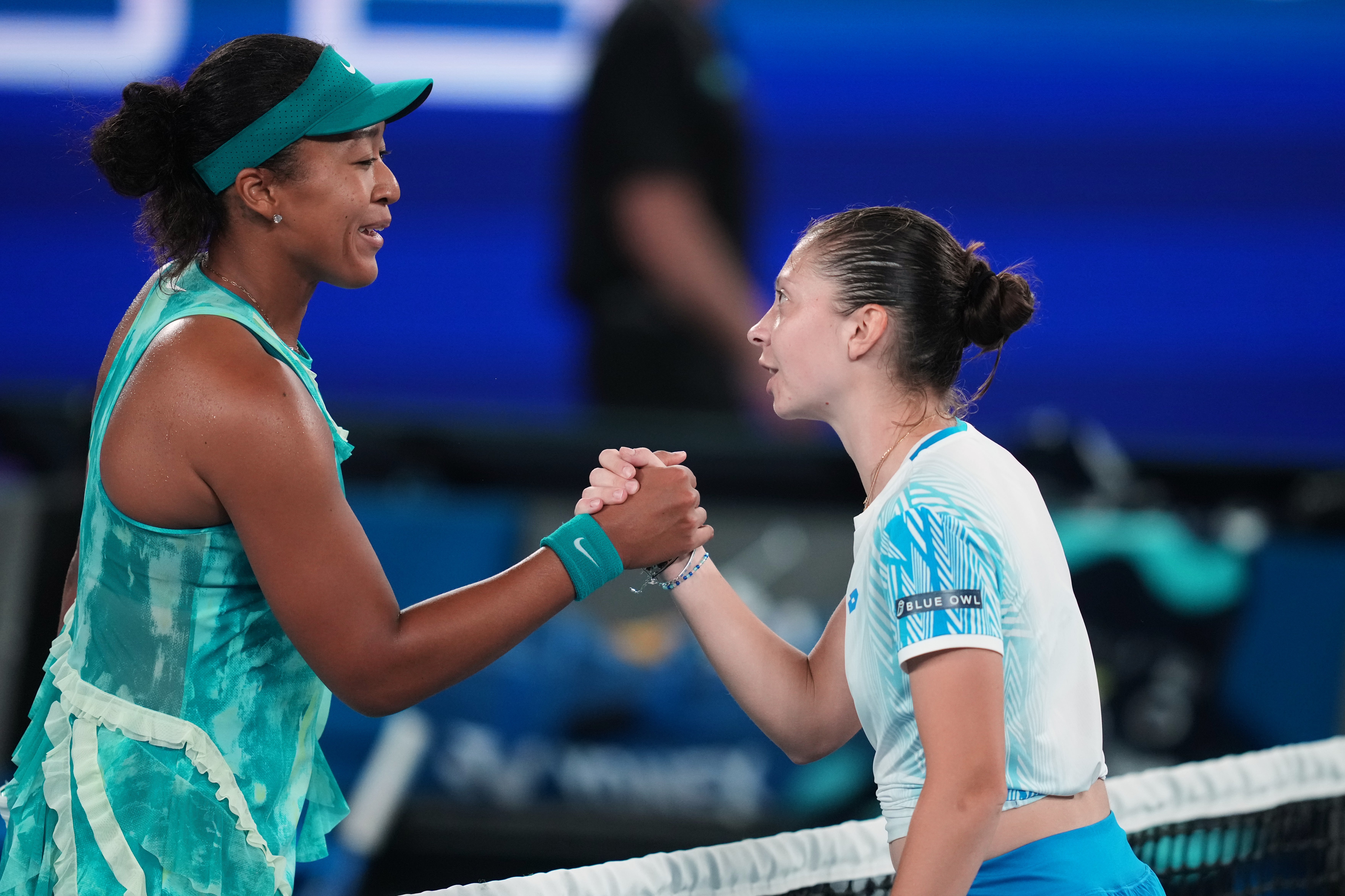 Naomi Osaka shakes hands with Antonia Ruzic, who lead by a break in the final set