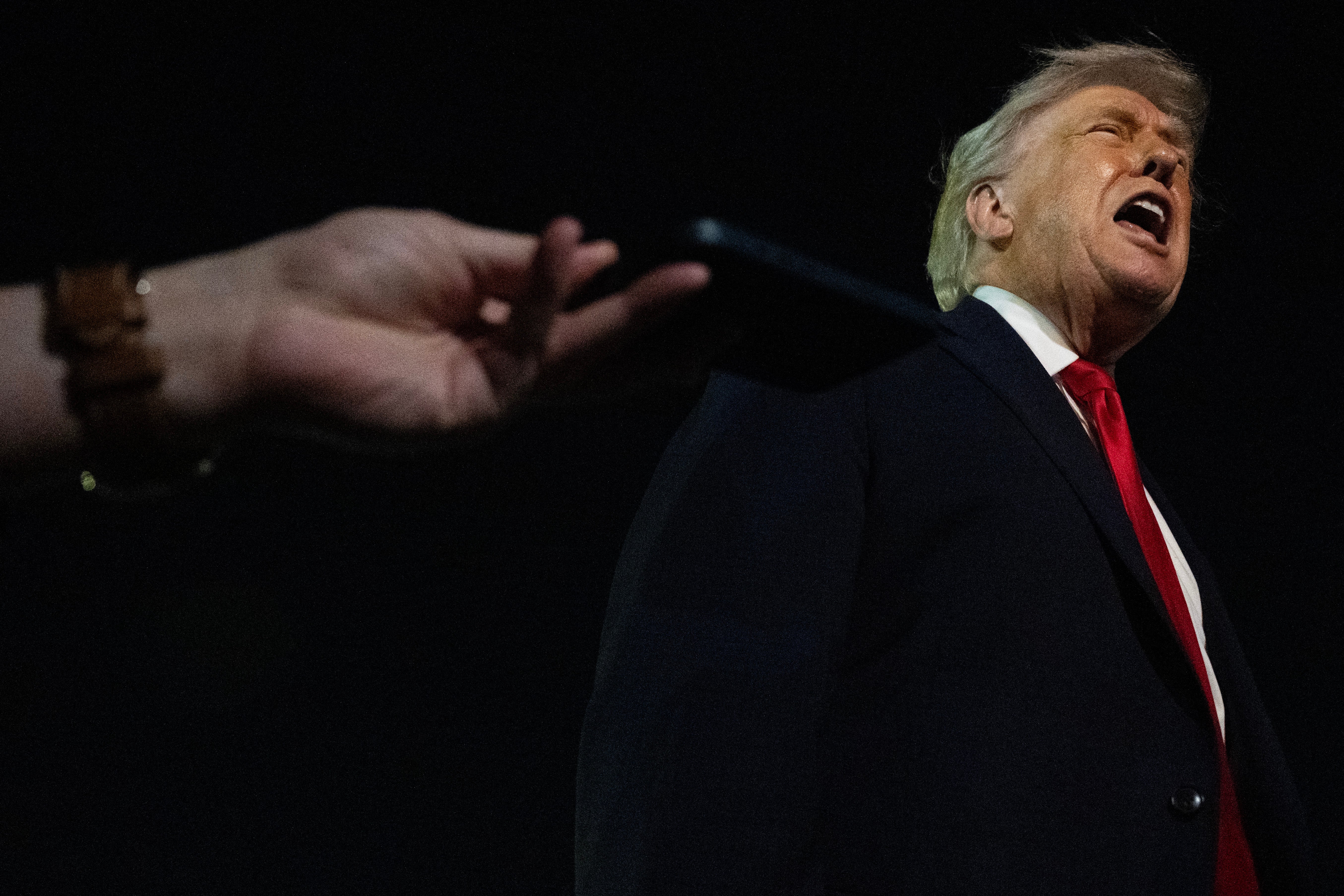 US President Donald Trump speaks with reporters before boarding Air Force One at Palm Beach International Airport in Florida