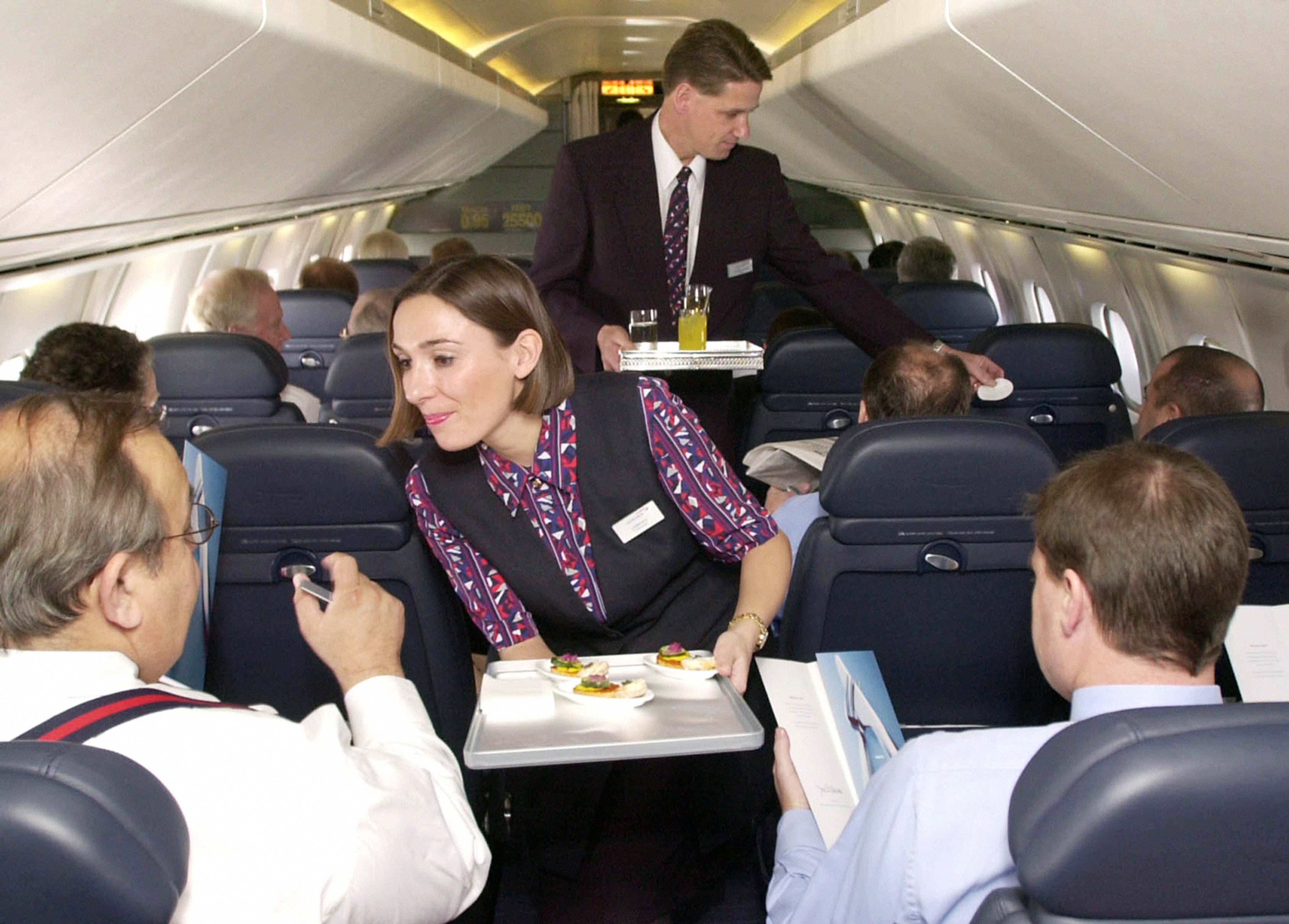 Concorde passengers are served by airline staff