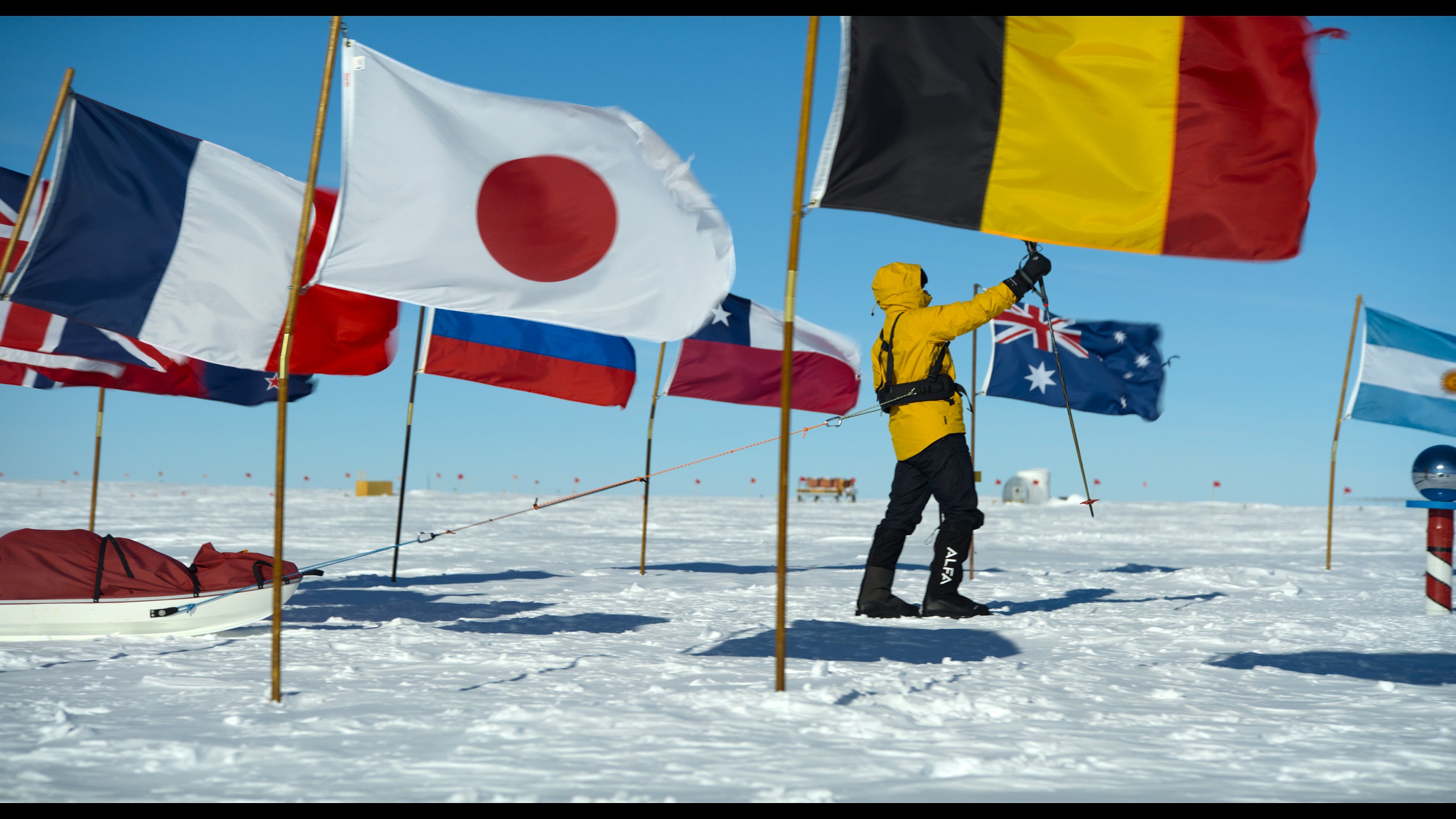 Will Smith skis past flags surrounding the South Pole on his trek to the southernmost point of the earth