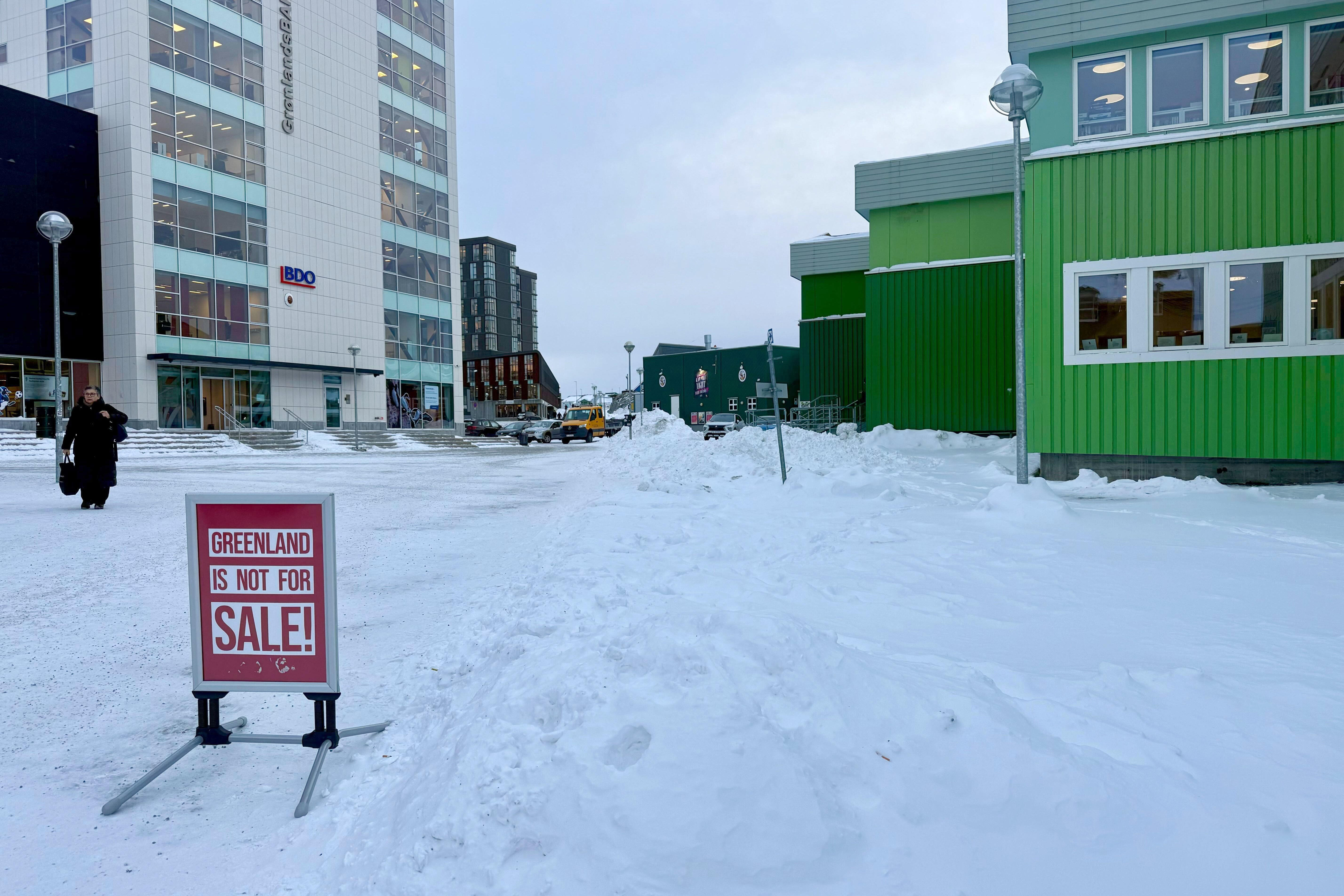 Signs throughout downtown Nuuk and in shop windows across the city resist Trump’s advances on Greenland