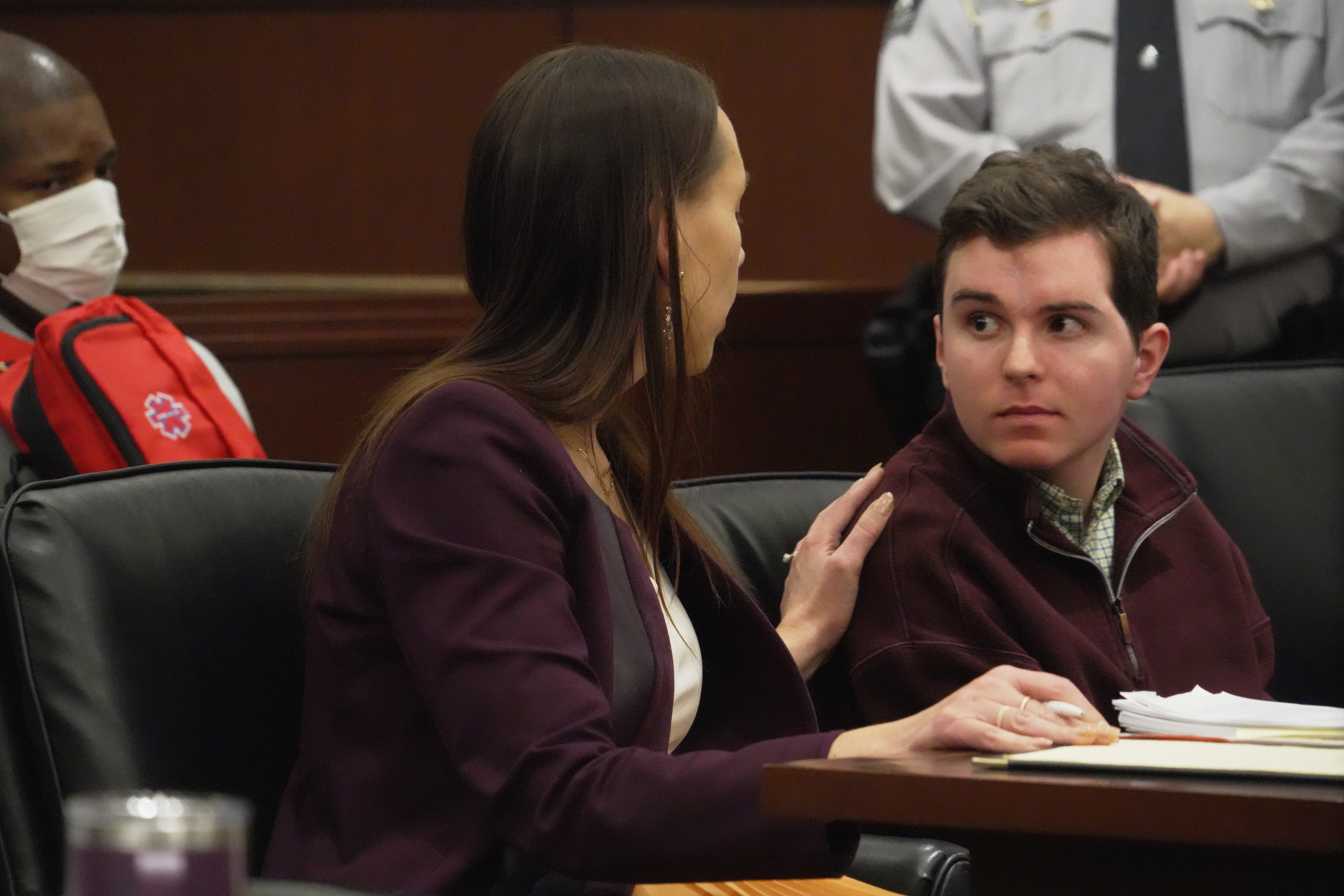 Defense attorney Kellie Mannette touches Austin Thompson's shoulder during a hearing in Wake County Superior Court on Wednesday, Jan. 21, 2026, in Raleigh, N.C. (AP Photo/Allen G. Breed)