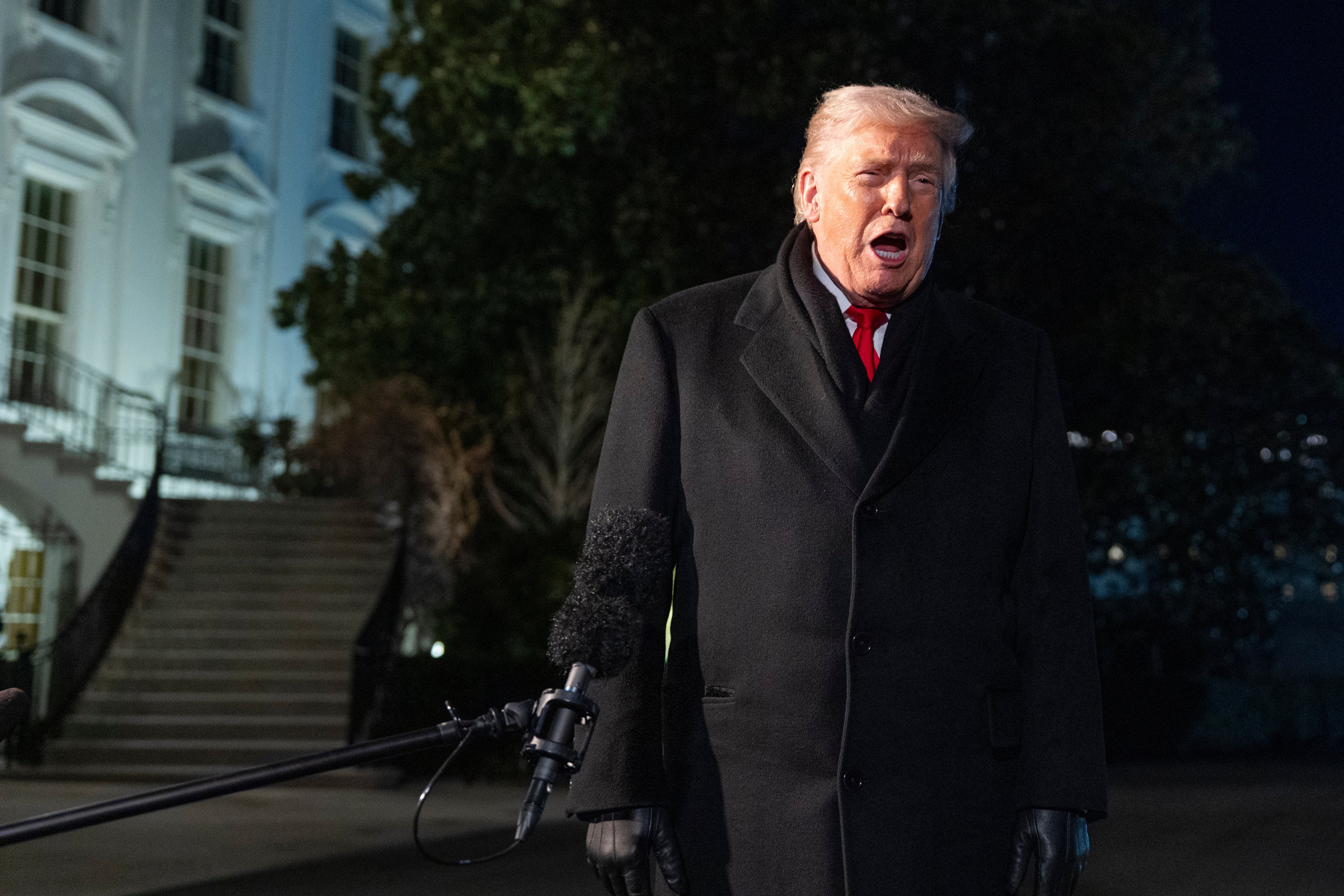 President Donald Trump speaks before departing on Marine One from the South Lawn of the White House, Tuesday, Jan. 20, 2026, in Washington