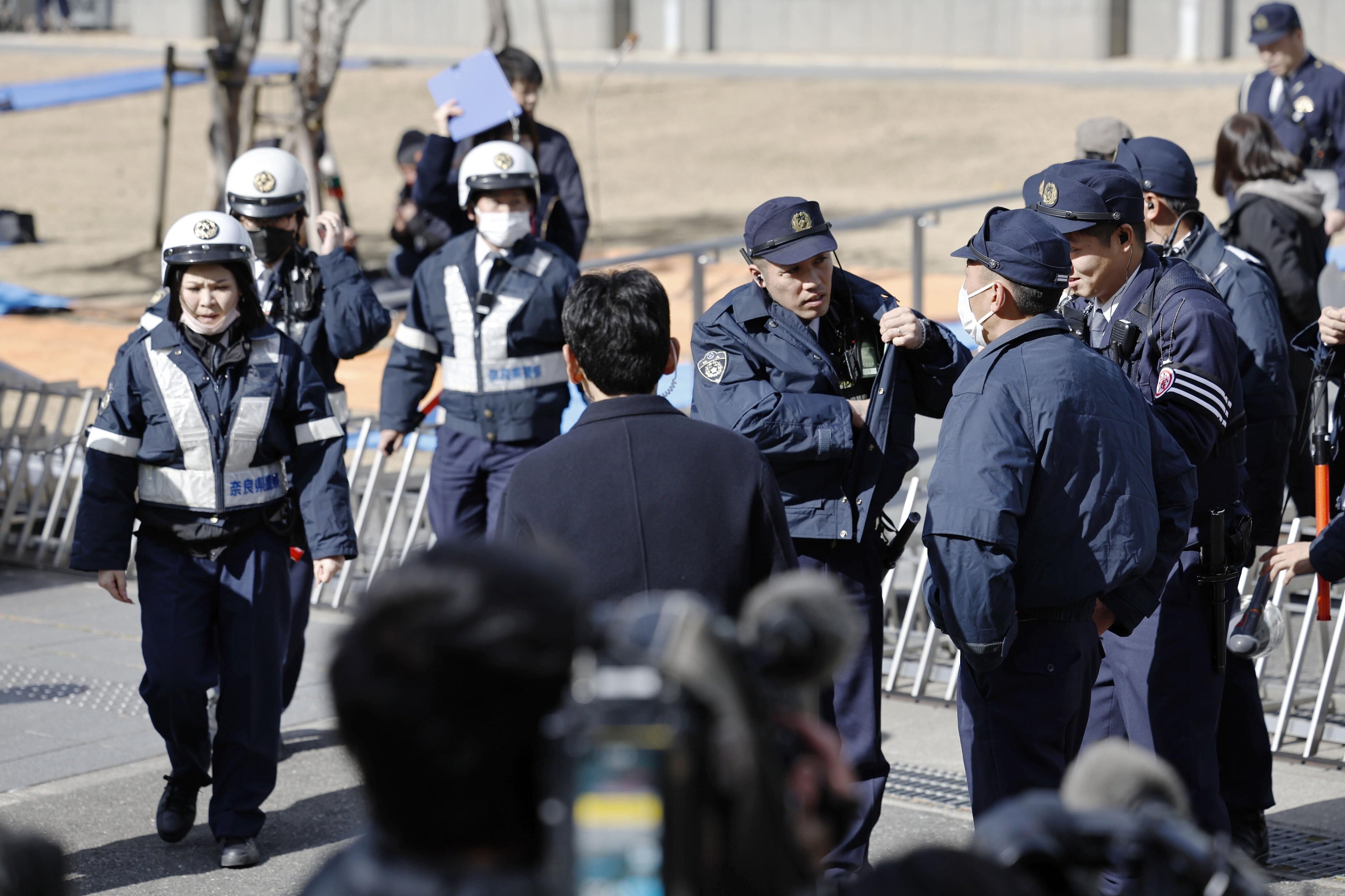Police officers stand guard outside the Nara District Court ahead of a sentence for Tetsuya Yamagami, the defendant accused of fatally shooting Japan's former prime minister Shinzo Abe, in Nara