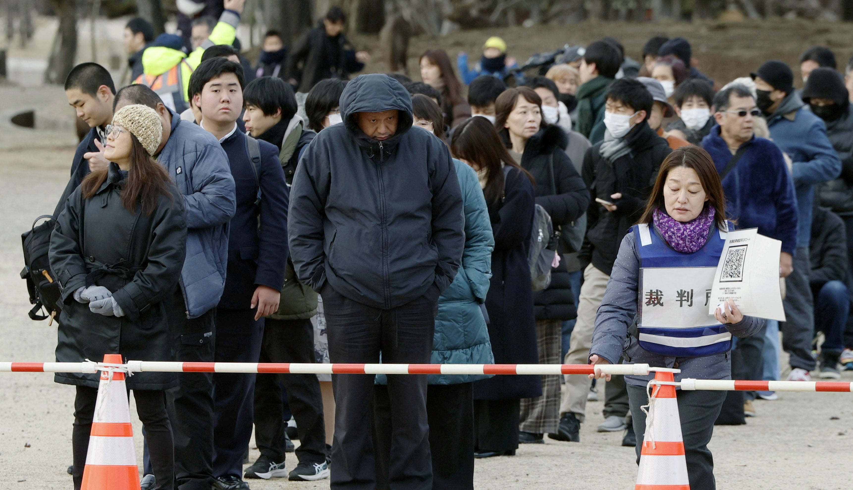 People queue to get courtroom seating lottery tickets ahead of a verdict on a man accused of fatally shooting former prime minister Shinzo Abe, near the Nara District Court in Nara, western Japan, 21 January 2026