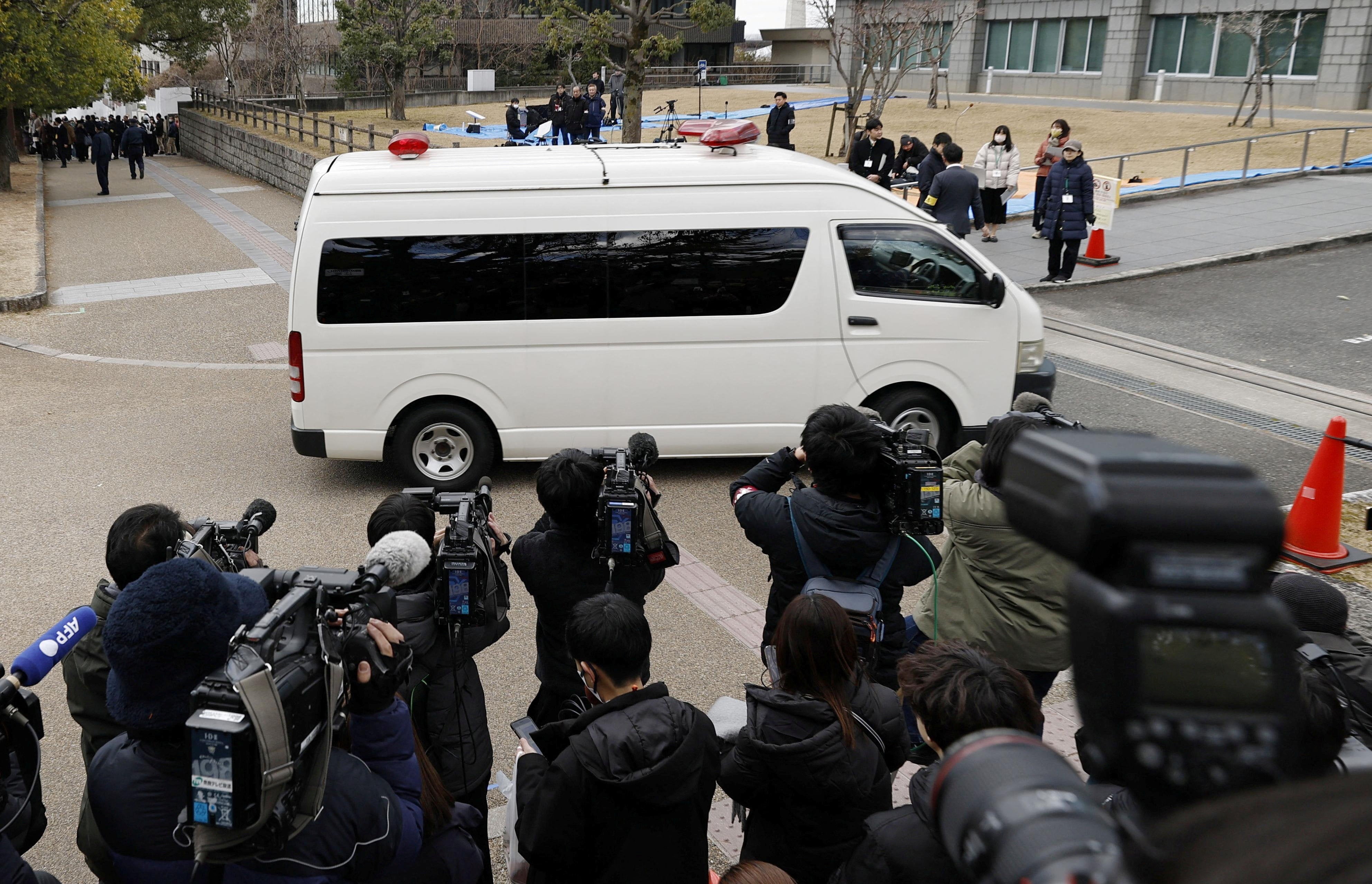 A vehicle carrying Tetsuya Yamagami, who is accused of fatally shooting former Prime Minister Shinzo Abe, enters the Nara District Court in Nara, western Japan, 21 January 2026
