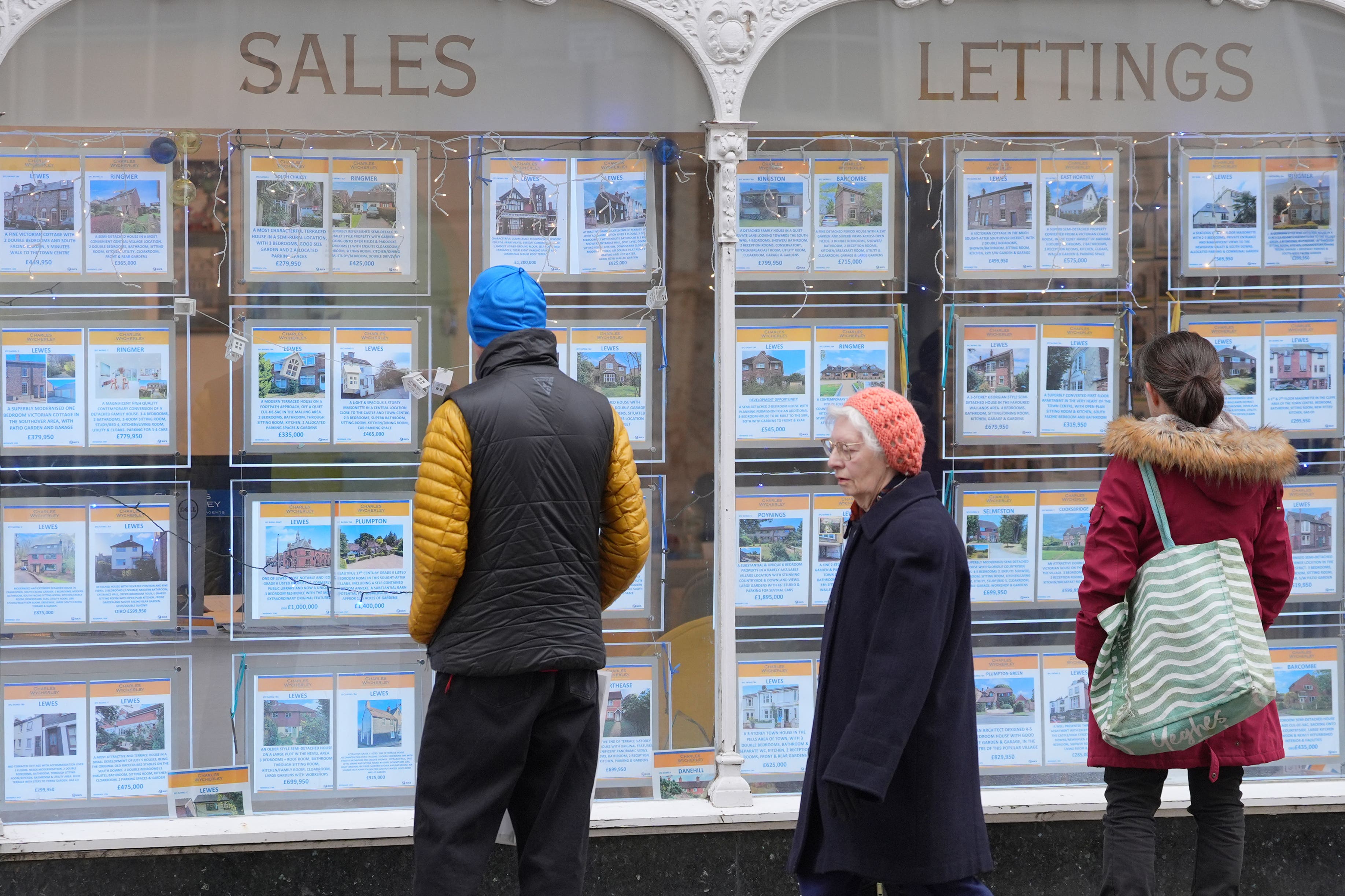 Properties for sale and to let are displayed in an estate agent window (Yui Mok/PA)