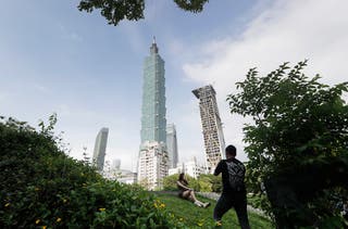 People take photos with the iconic Taipei 101 skyscraper in the background in Taiwan capital Taipei