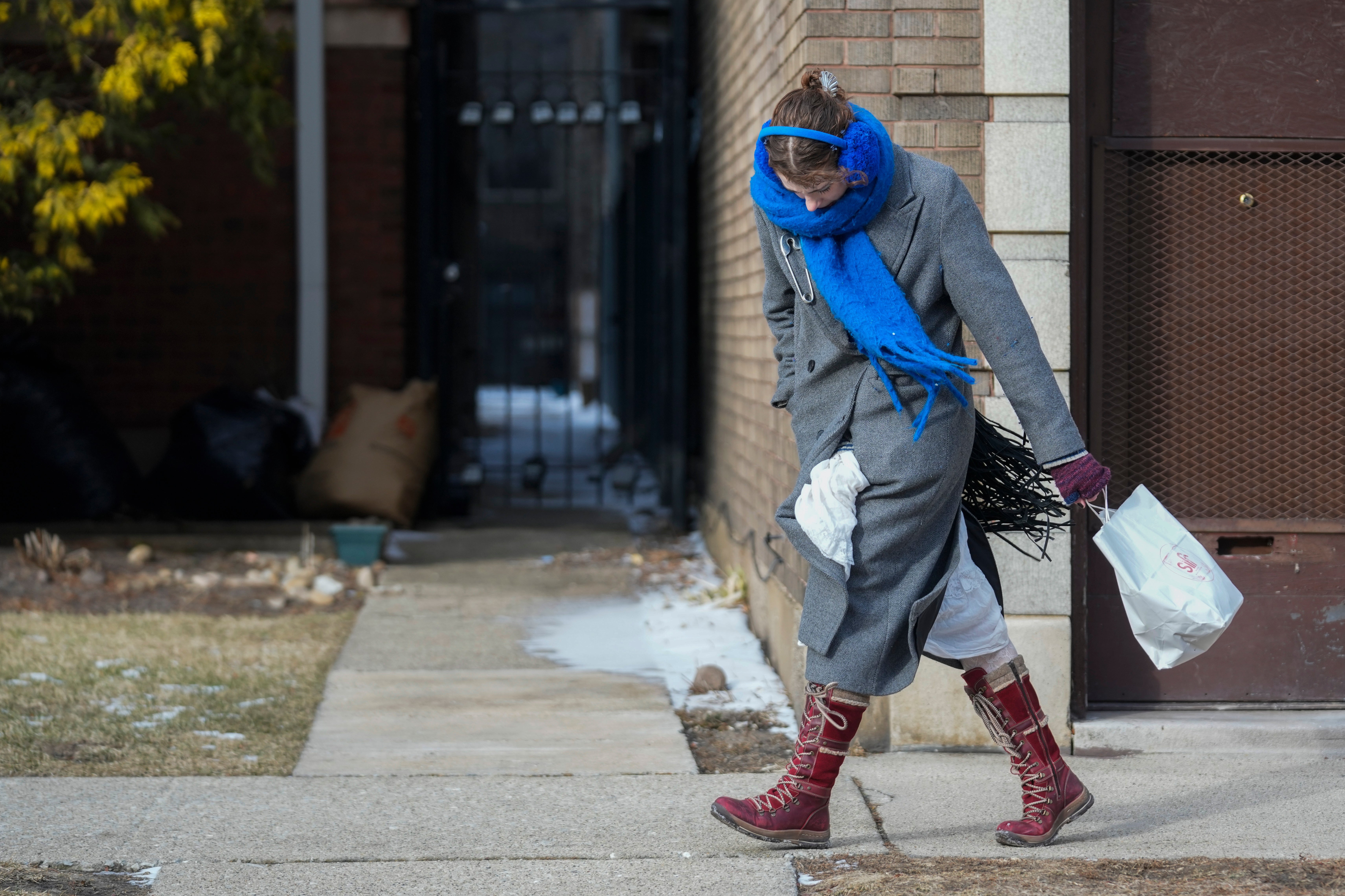 A person walks in the cold and wind Wednesday, Jan. 21, 2026, in Chicago. (AP Photo/Erin Hooley)