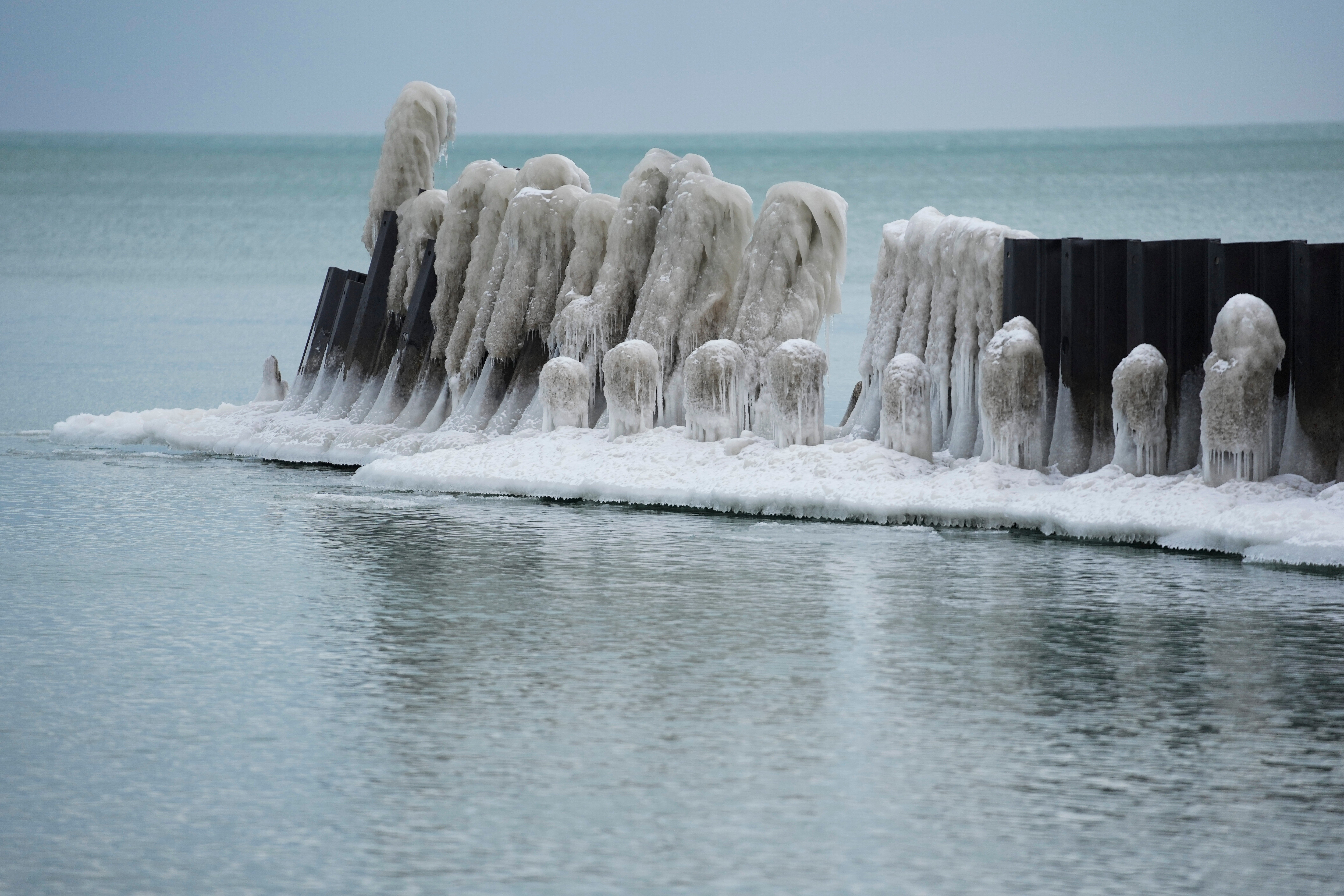 Ice forms on a pier along Lake Michigan ona. cold Wednesday, Jan. 21, 2026, in Chicago. (AP Photo/Erin Hooley)