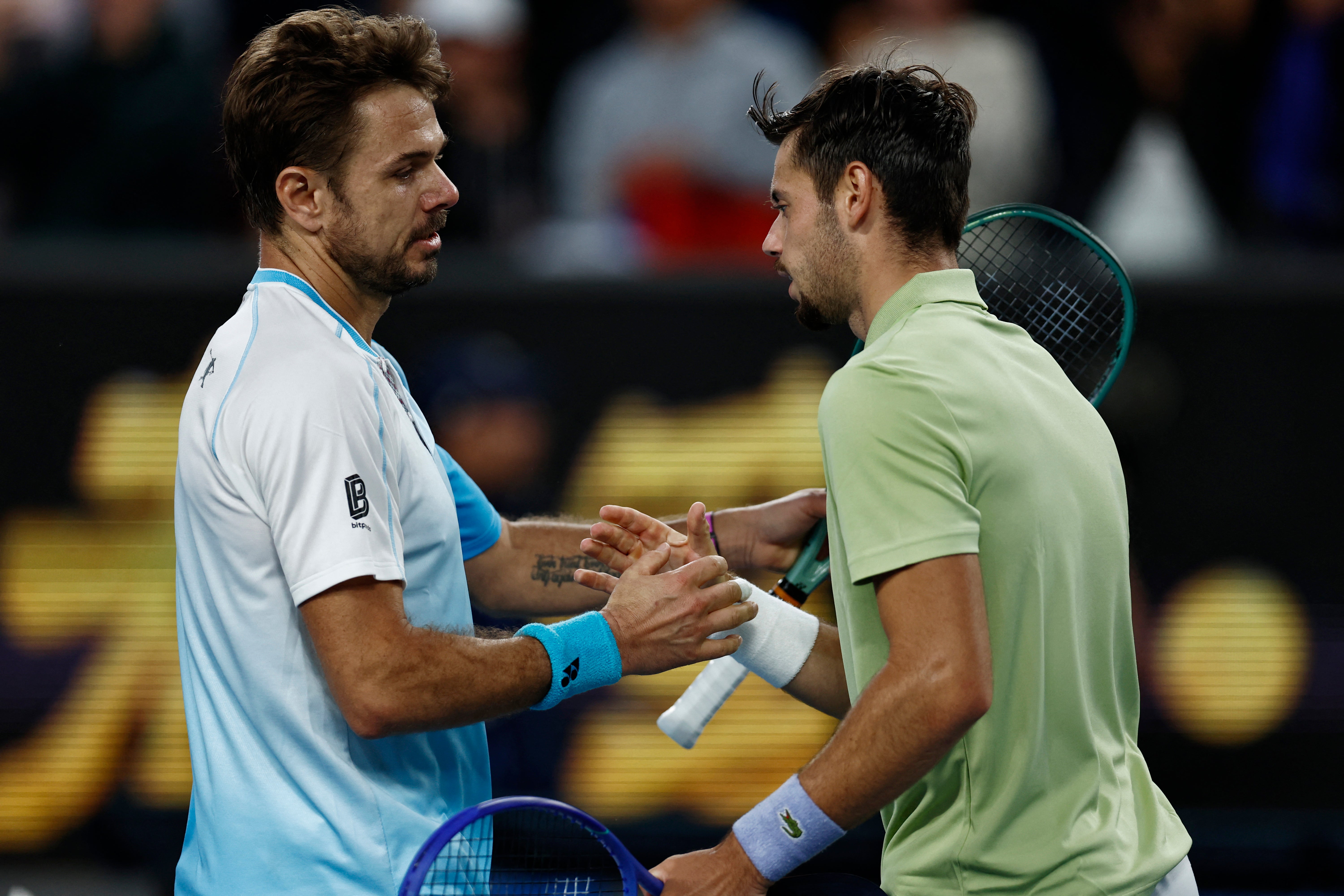 Stan Wawrinka shakes hands with France's Arthur Gea