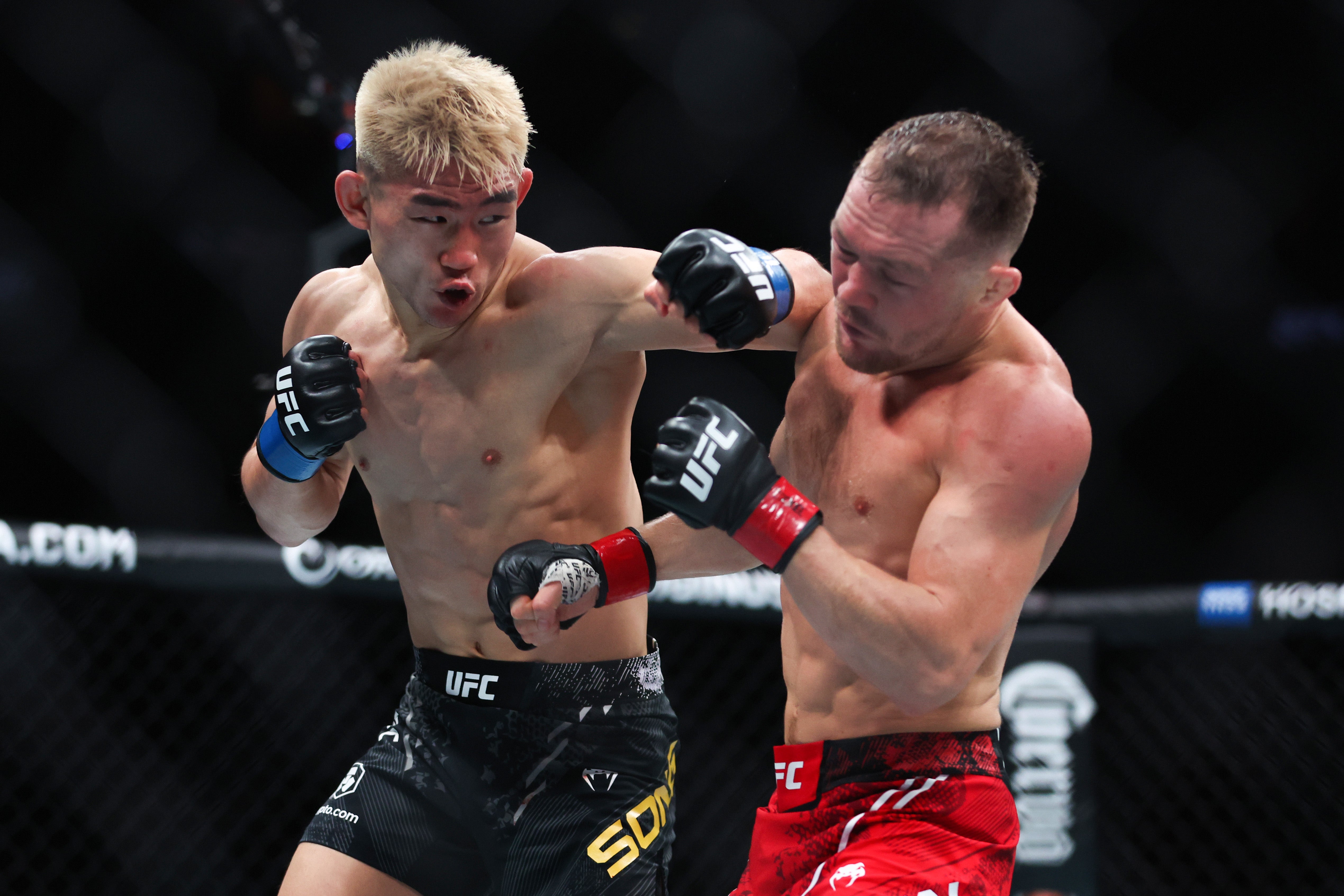 Song Yadong (left) during his 2024 loss to Petr Yan