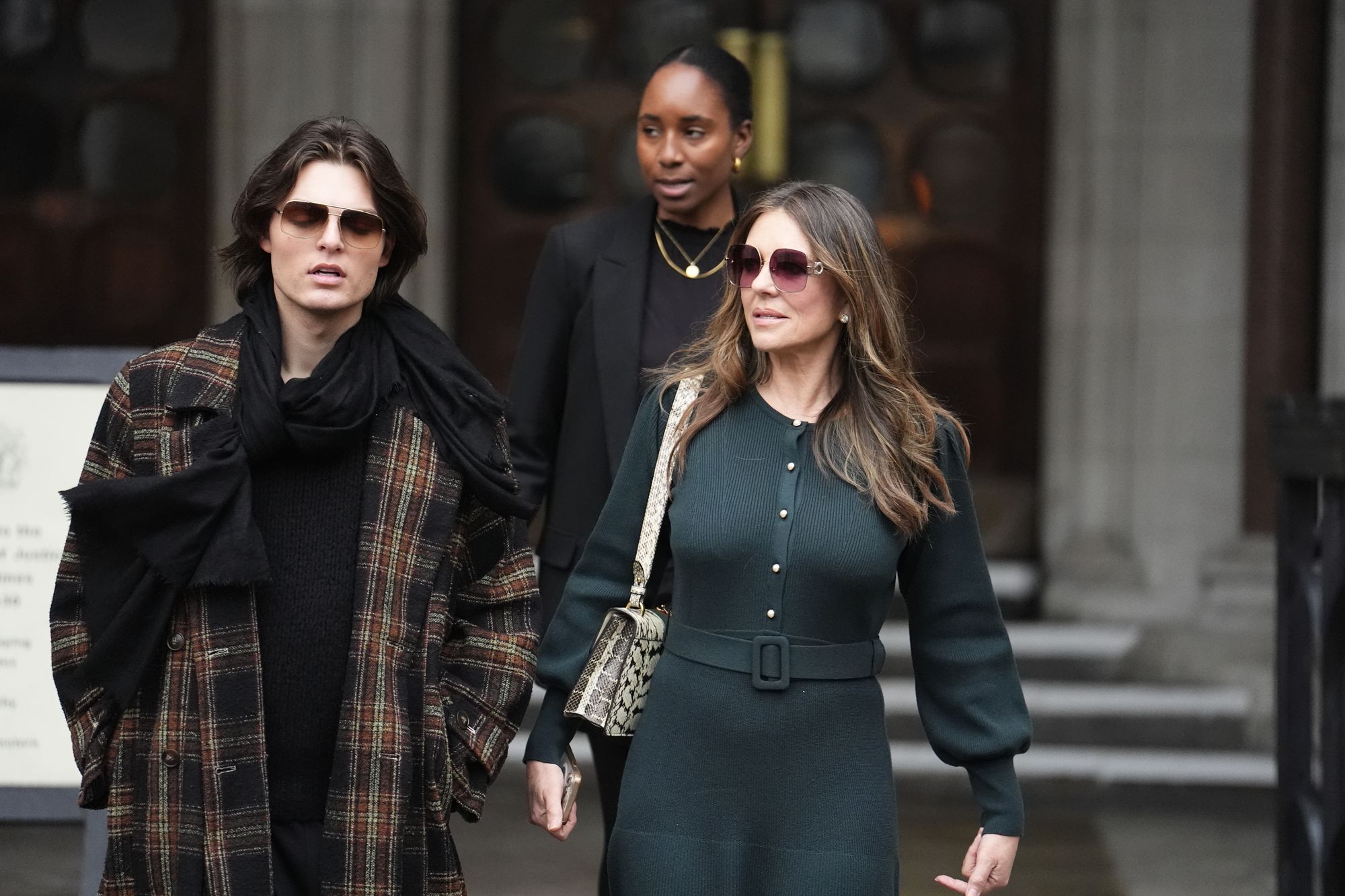 Elizabeth Hurley, right, leaves the Royal Courts of Justice on day four of the trial last month