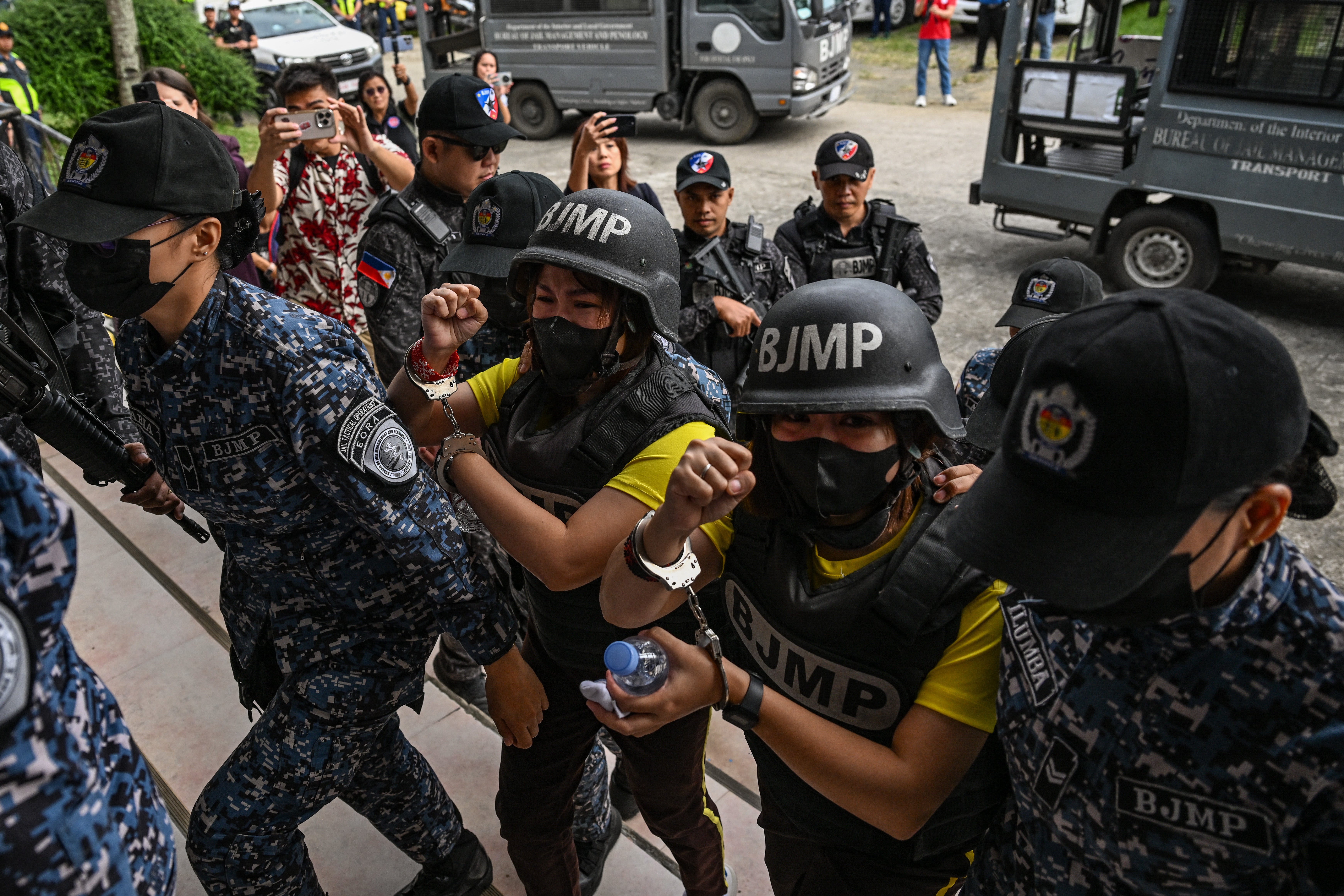 <p>Frenchie Mae Cumpio (R, wearing yellow), a detained Filipino journalist, and her former roommate Marielle Domequil (L, wearing yellow) arrive at Tacloban Regional Trial Court in Leyte island on 22 January 2026, to attend the promulgation of her court case</p>