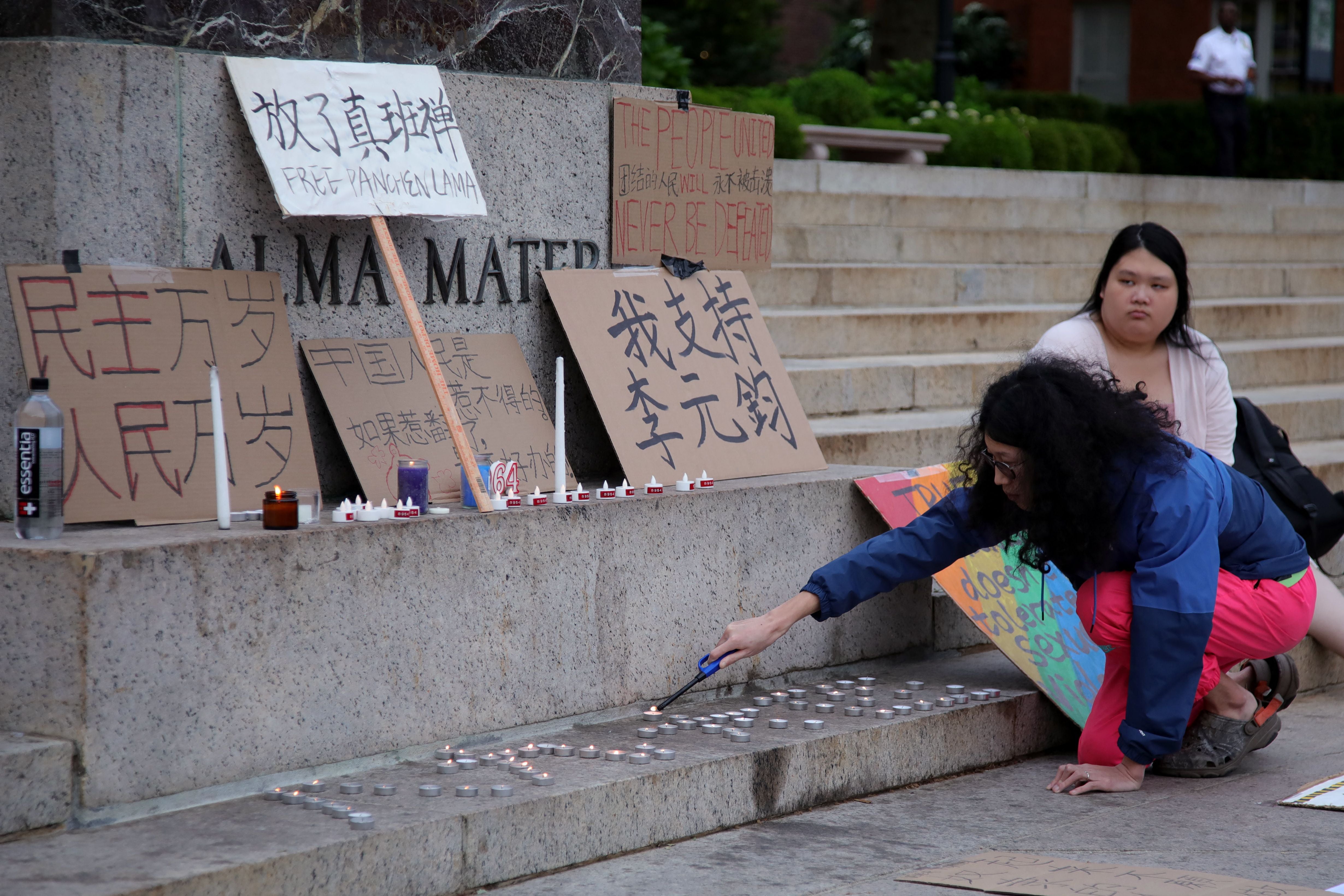 File. People light candles as they attend a vigil on the 34th anniversary of the crackdown of pro-democracy demonstrations around Tiananmen Square in Beijing, at Columbia University in New York City on 4 June 2023