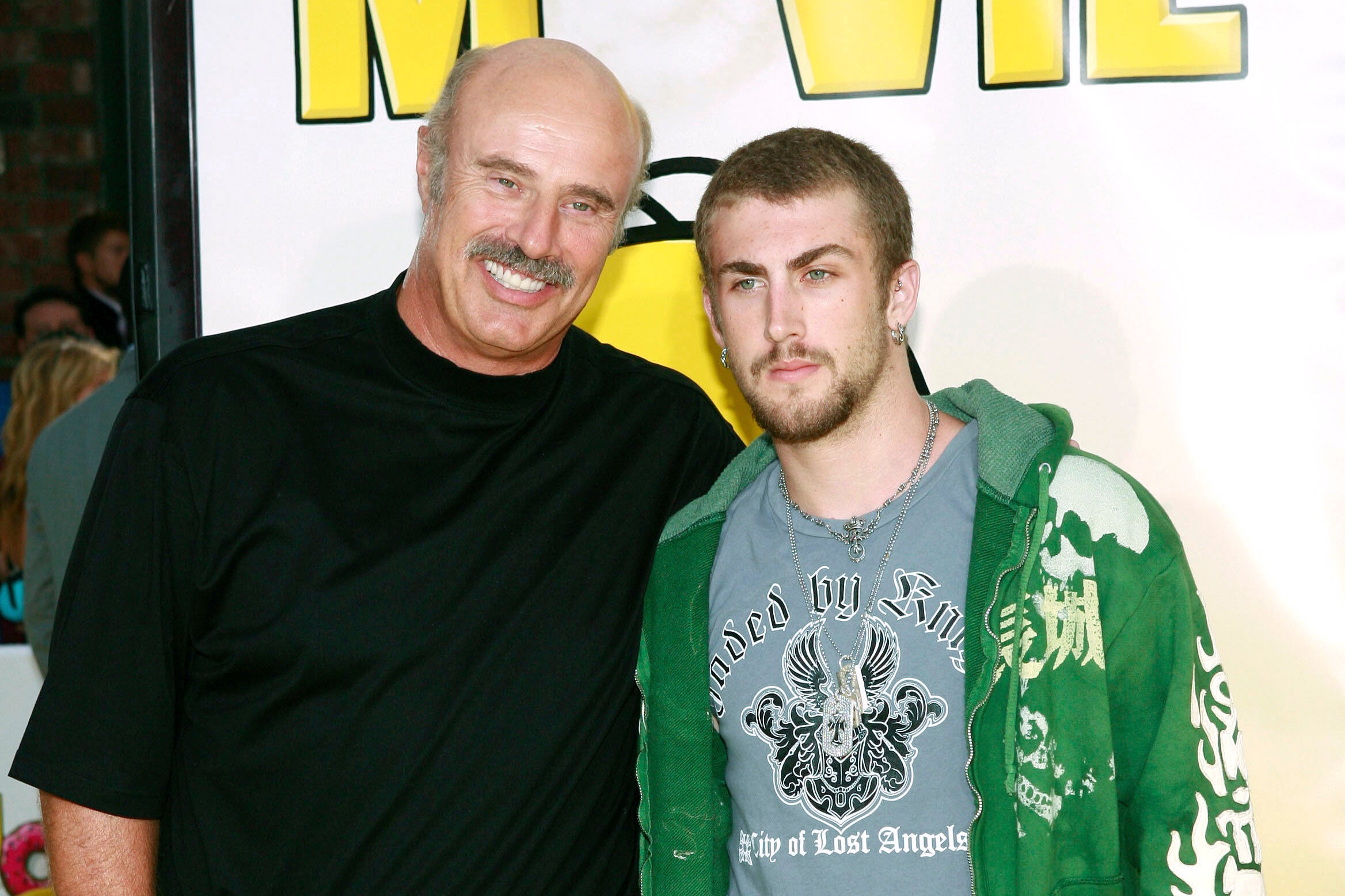 Dr. Phil McGraw, left, and his son, Jordan McGraw, arrive at the premiere of 'The Simpsons Movie' in Los Angeles, July 24, 2007. (AP Photo/Matt Sayles, File)