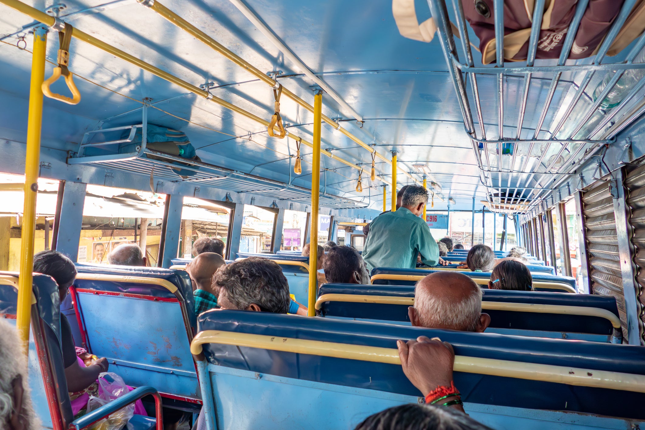 <p>File image: People inside a local Indian bus riding on the highway</p>