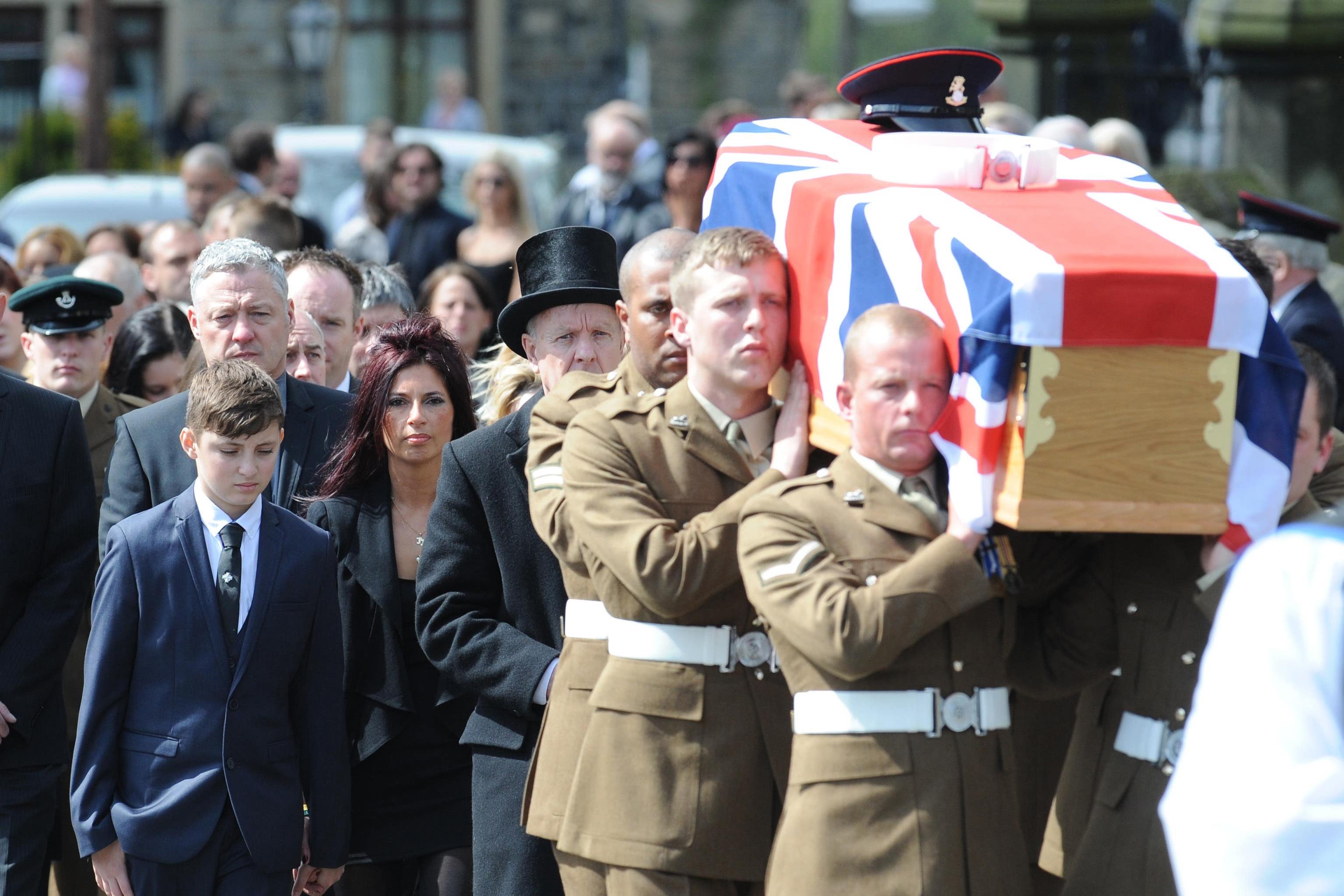 The family of Corporal Jake Hartley (left to right) brother Ethan, stepfather Mark Taylor and mother Nathalie Taylor follow his coffin after his funeral service at Christ Church, New Mill, Holmfirth, West Yorkshire (Anna Gowthorpe/PA)