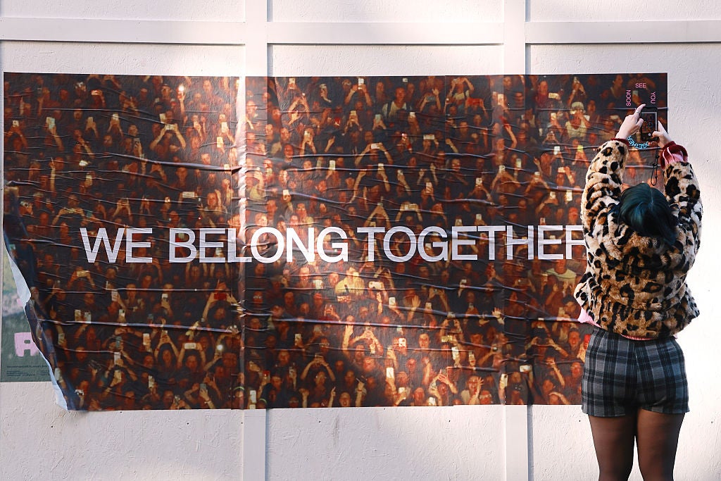 A Harry Styles "We Belong Together" poster is seen on a wall in Soho