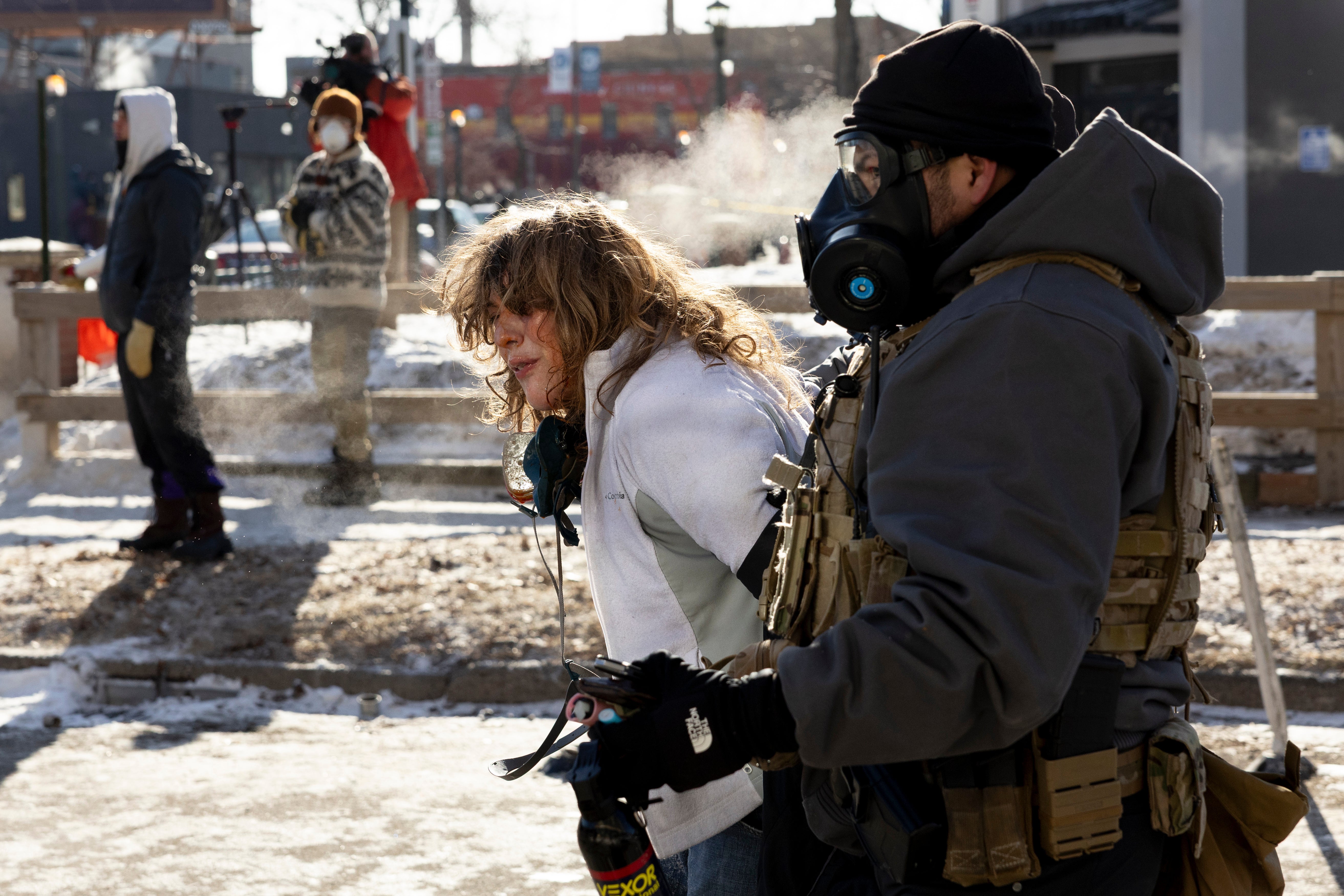 A protester is detained by officials