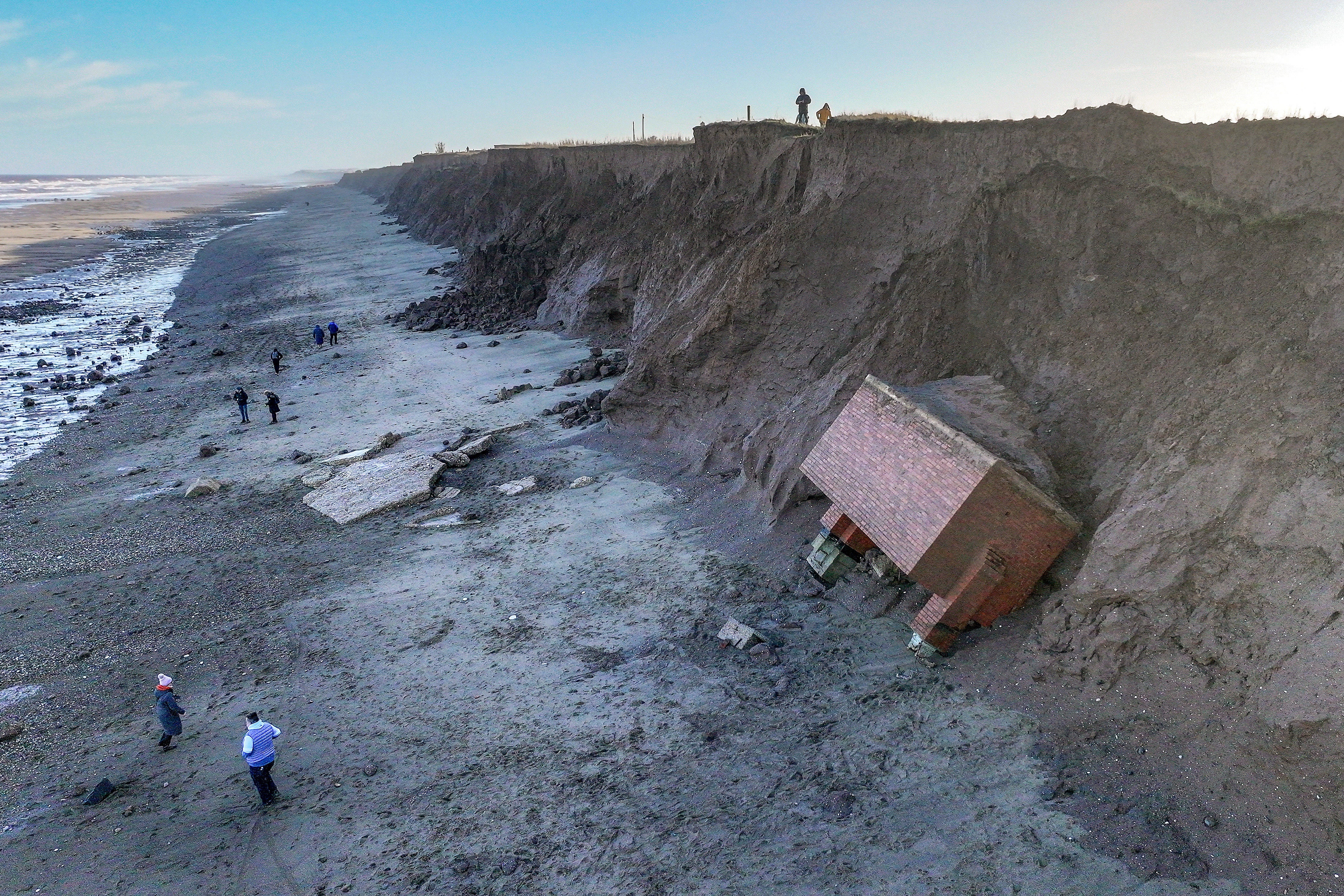 A decommissioned Cold War nuclear observation post fell onto the beach after clinging perilously to the cliff face for the last month in Tunstall
