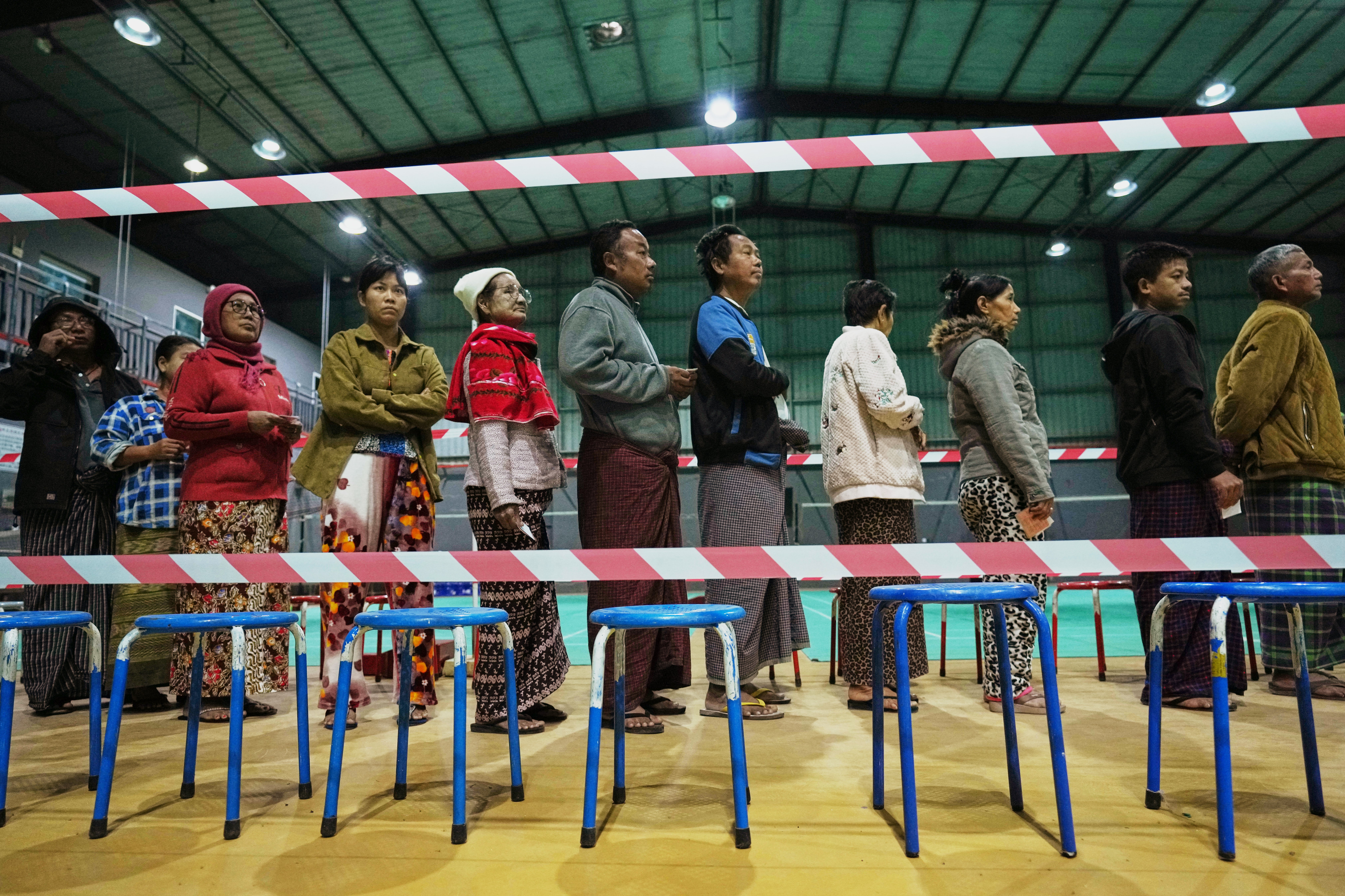 Voters line up to cast ballots at a polling station during the final round of general elections in Mandalay, central Myanmar