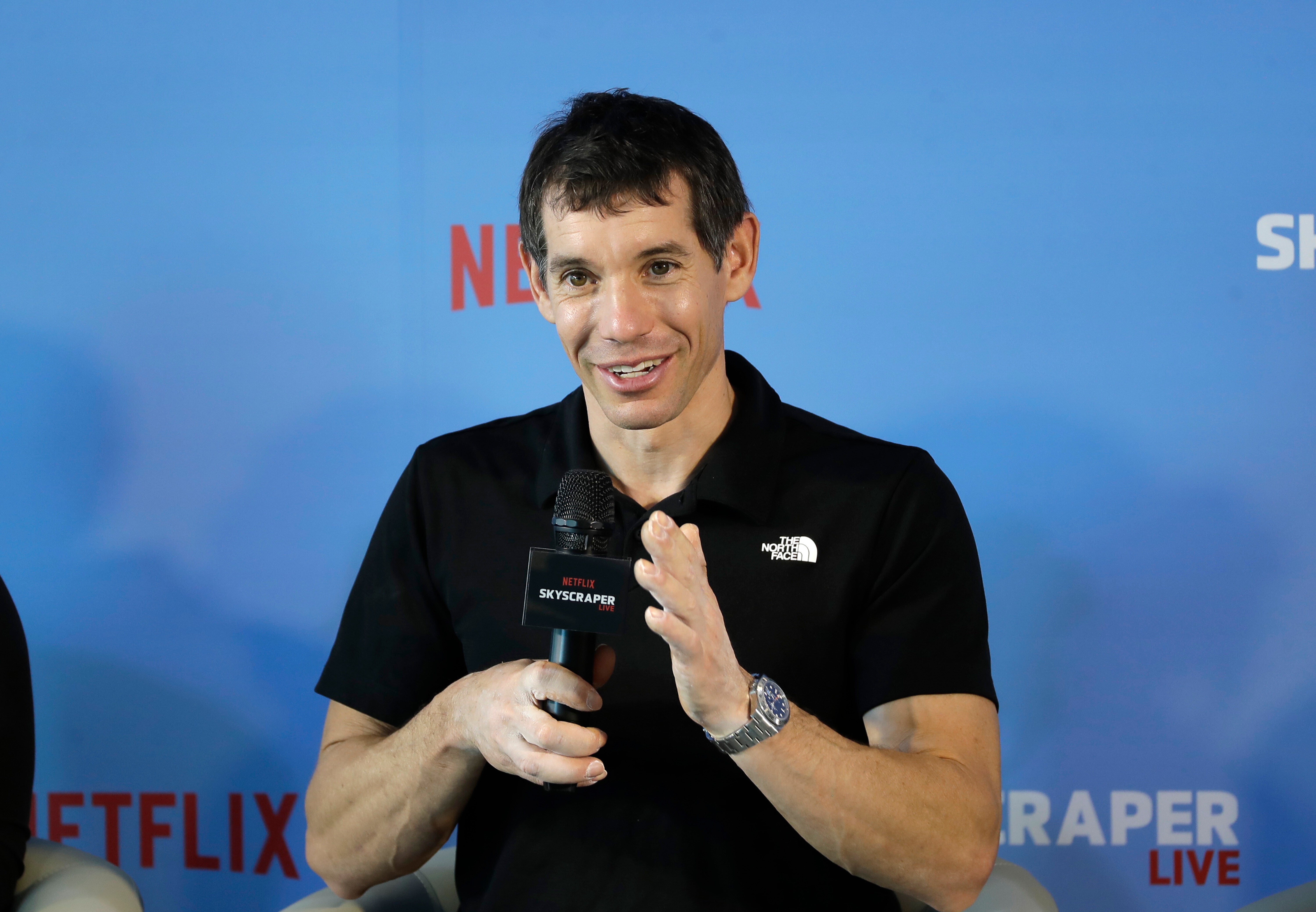 Rock climber Alex Honnold, of the US, responds to a reporter during a news conference after he completed a free solo climb of the Taipei 101 skyscraper in Taipei, Taiwan